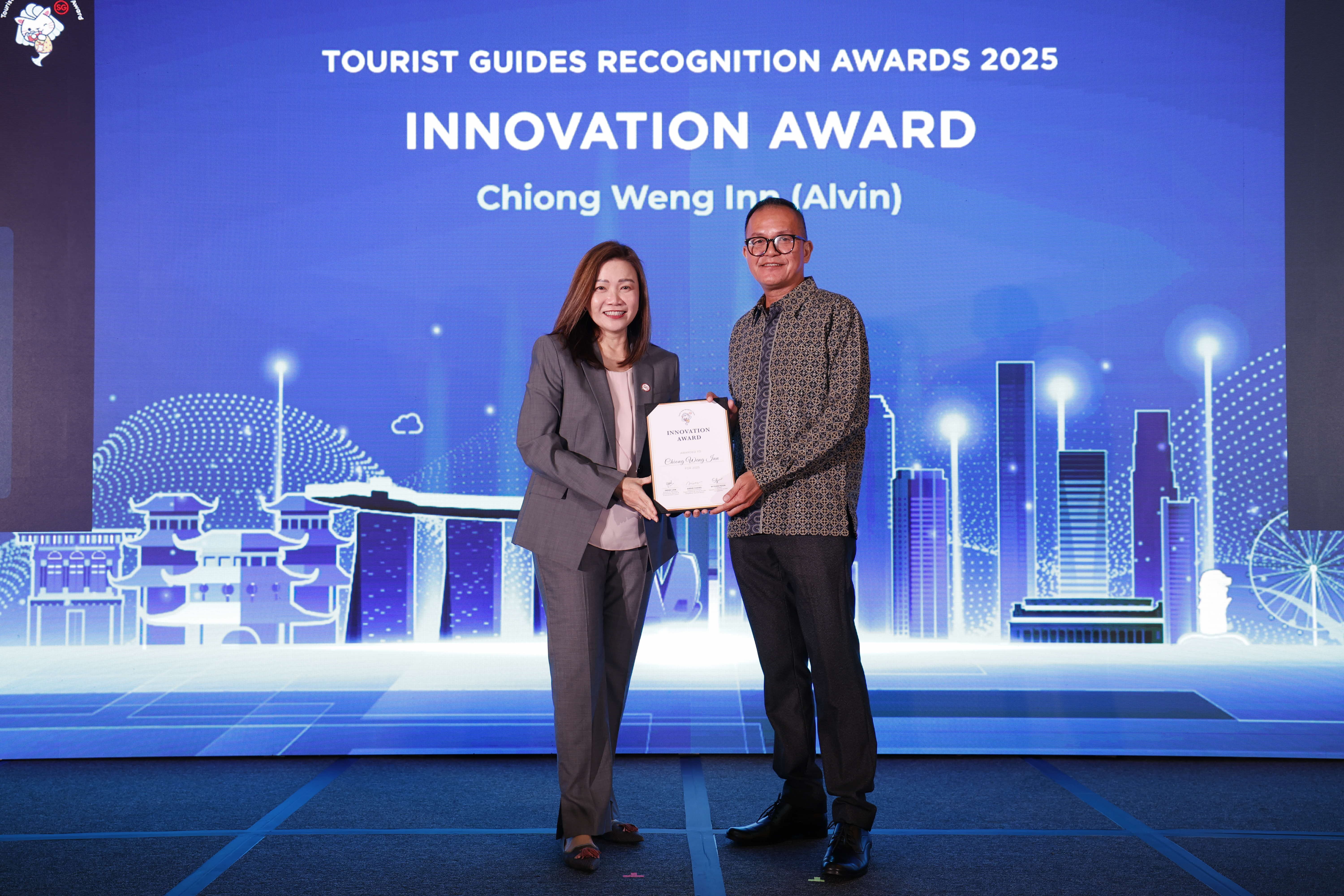 Alvin Chiong Weng Inn being presented the Innovation Award by STB Chief Executive Ms Melissa Ow.