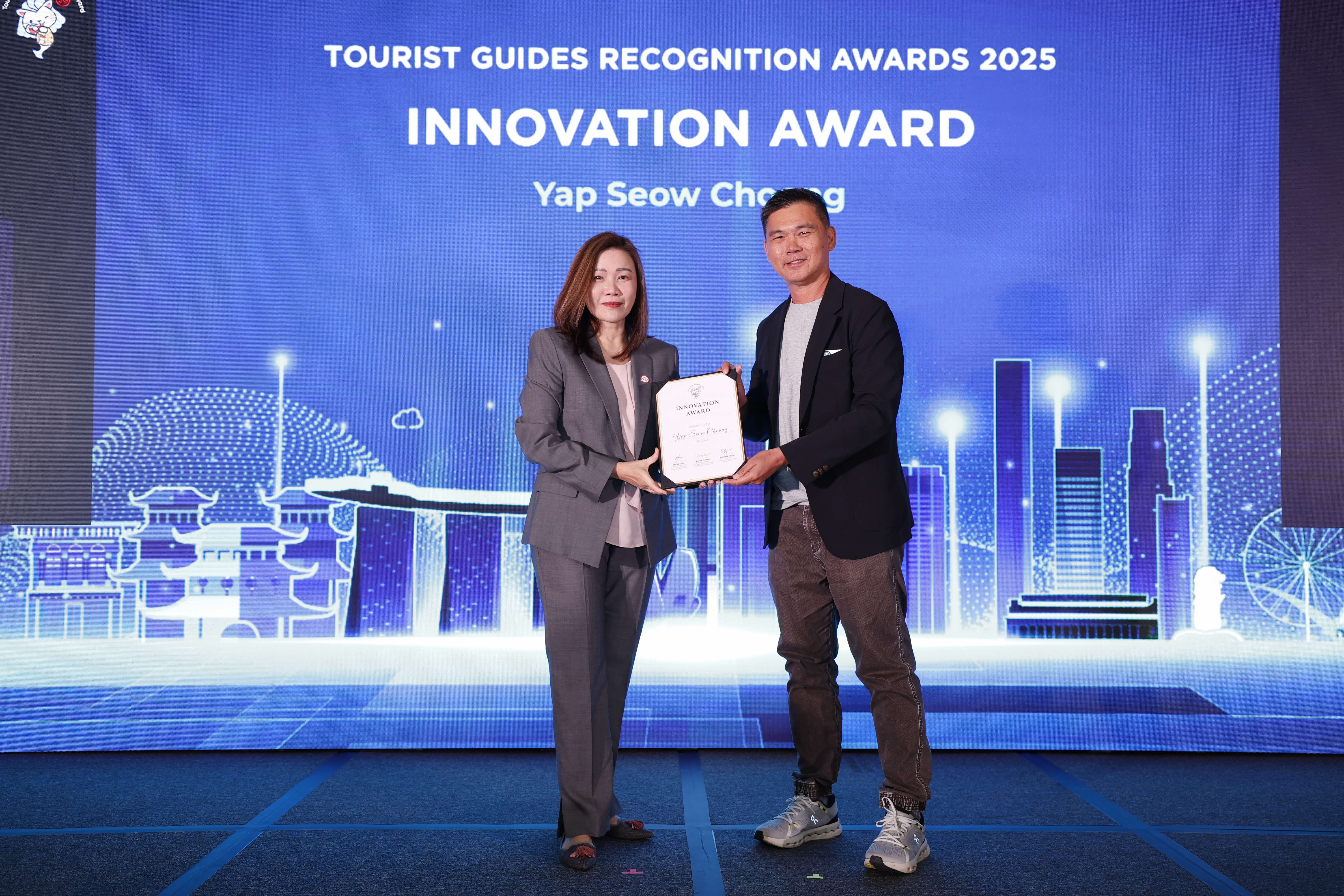 Yap Seow Choong being presented the Innovation Award by STB Chief Executive Ms Melissa Ow.