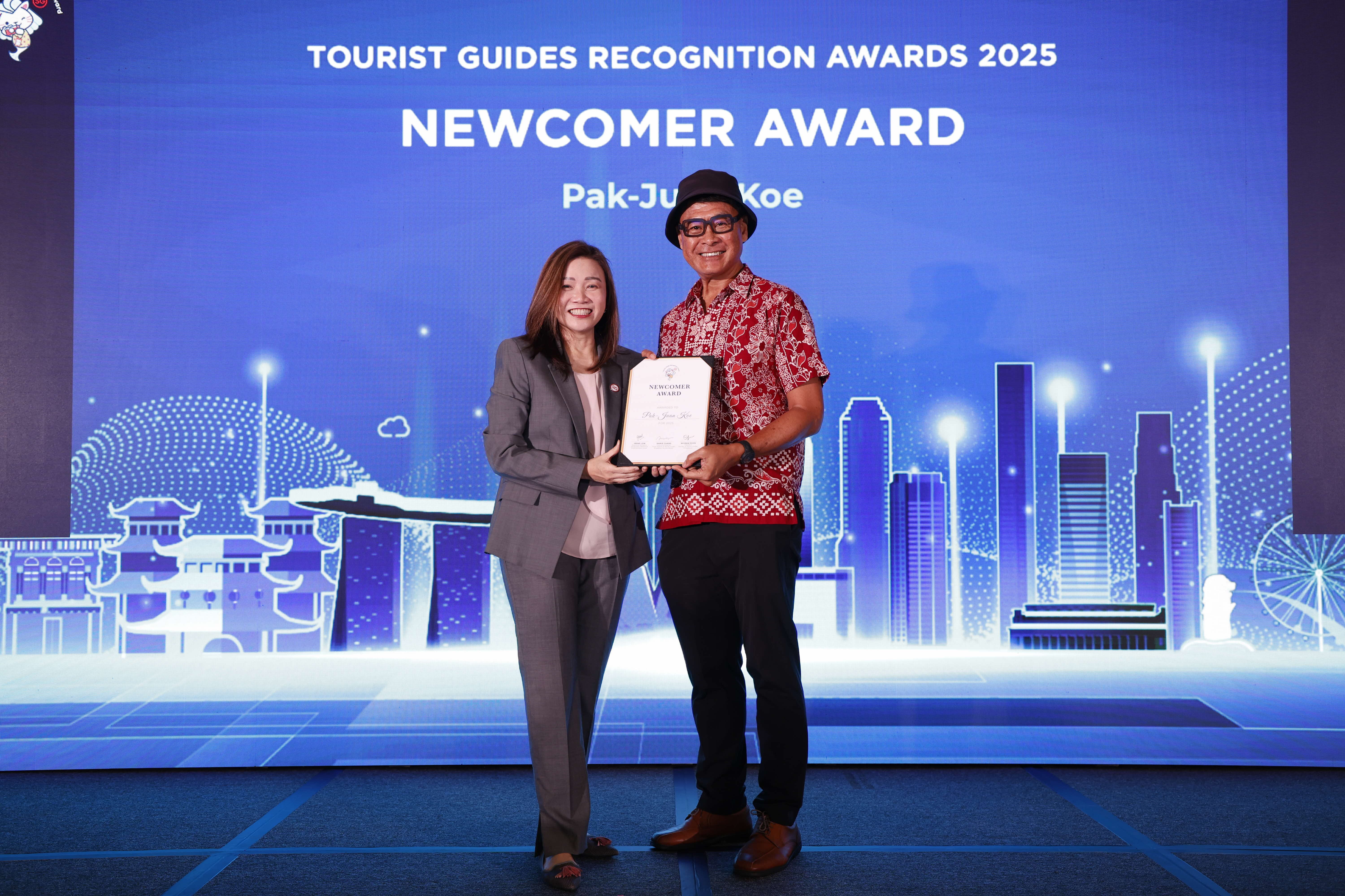 Pak-Juan Koe receiving the Newcomer Award from STB Chief Executive Ms Melissa Ow.