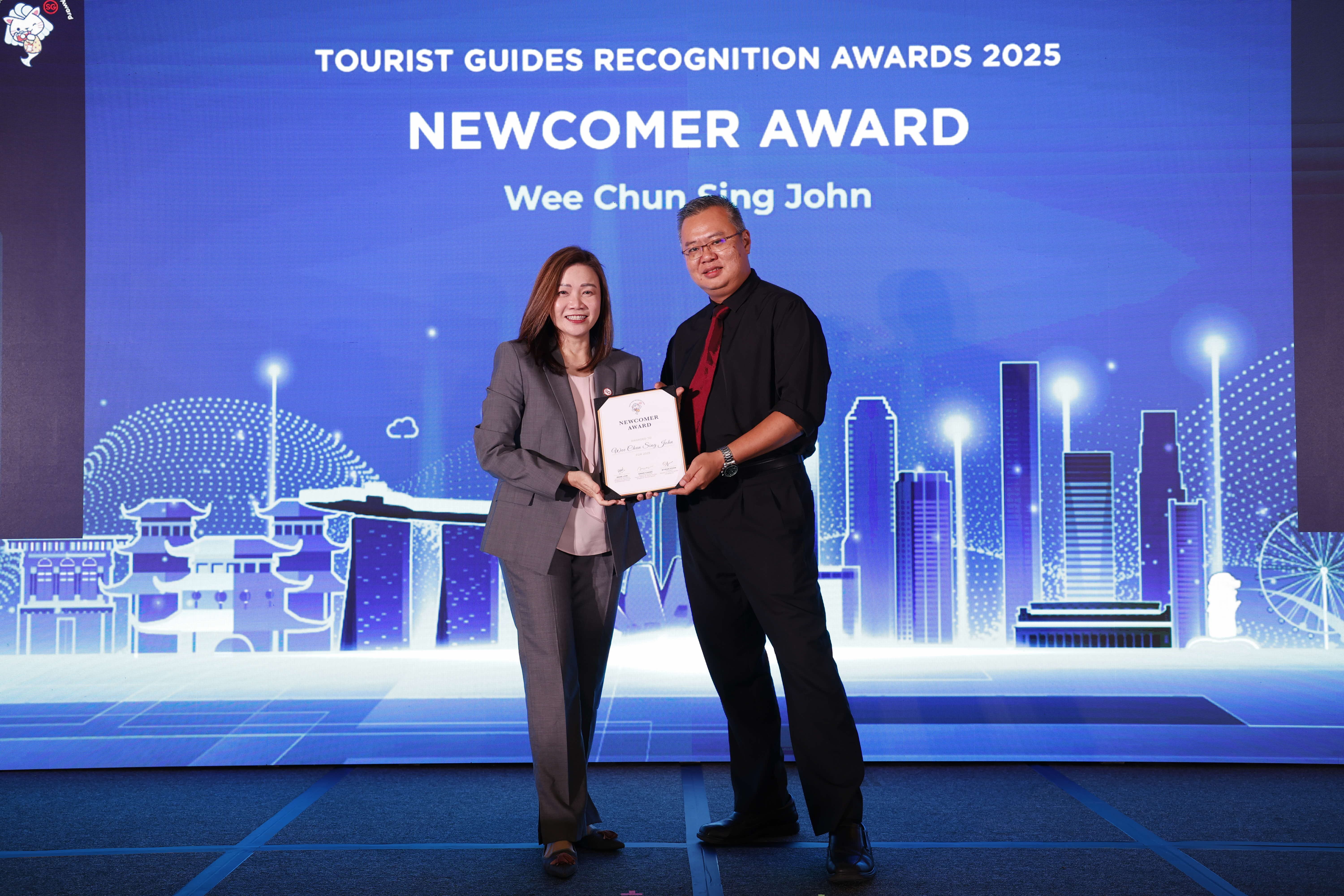 John Wee Chun Sing being presented the Newcomer Award by STB Chief Executive Ms Melissa Ow.