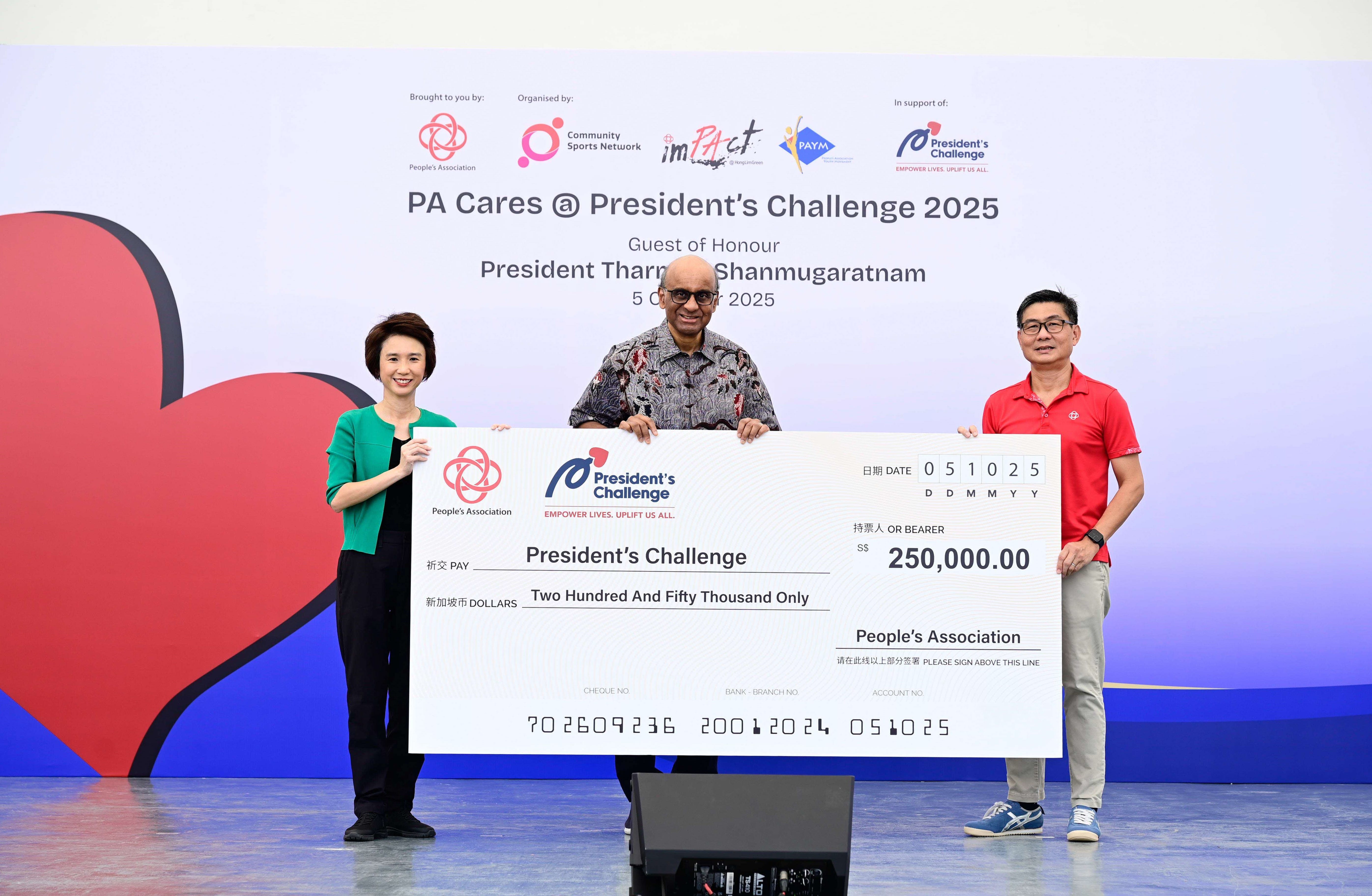 Three people are holding a large check for $250,000 at PA Cares @ President's Challenge 2025.