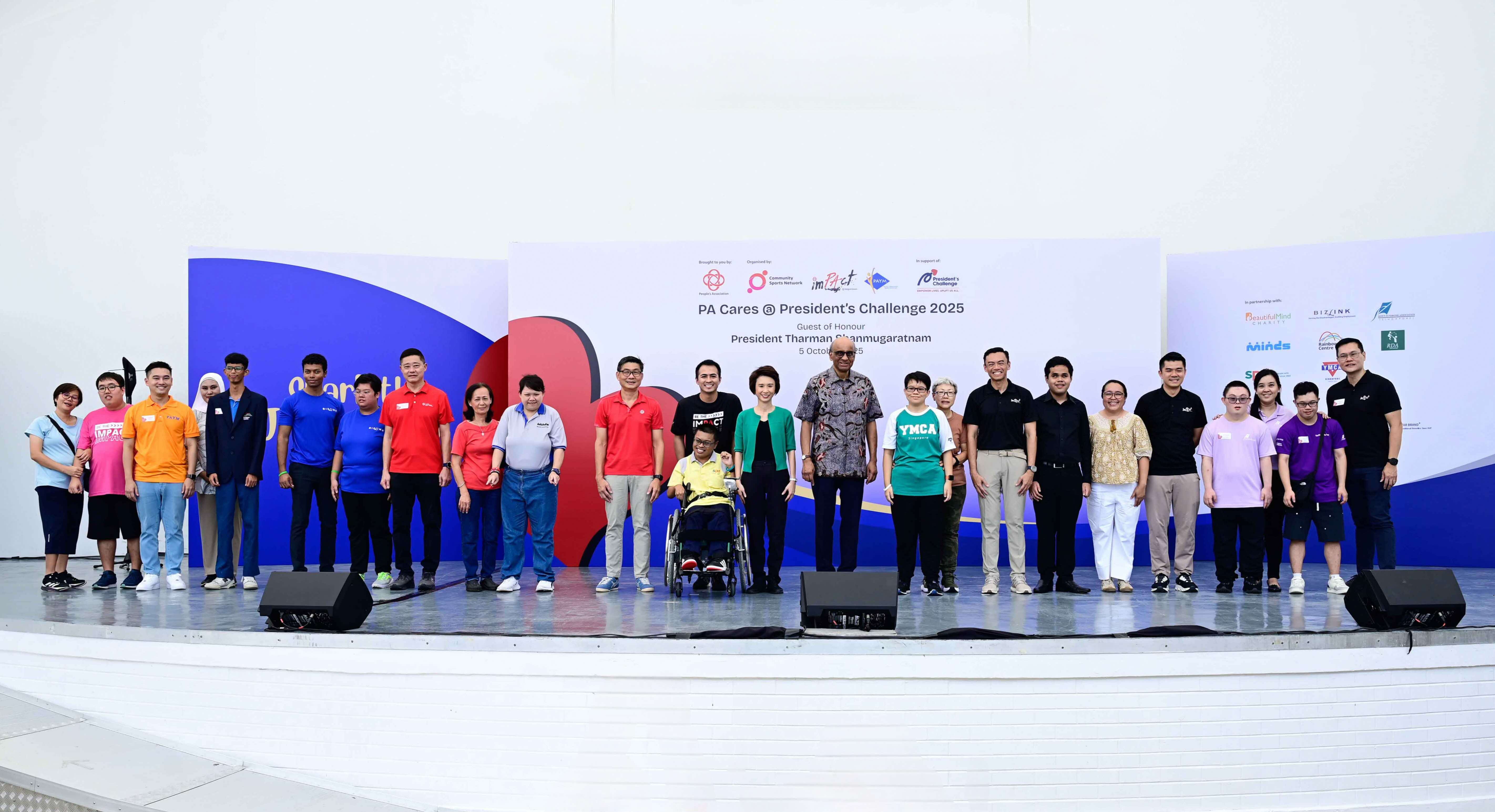 A group of individuals stand on a stage with a banner reading "PA Cares @ President’s Challenge 2025" featuring various logos.