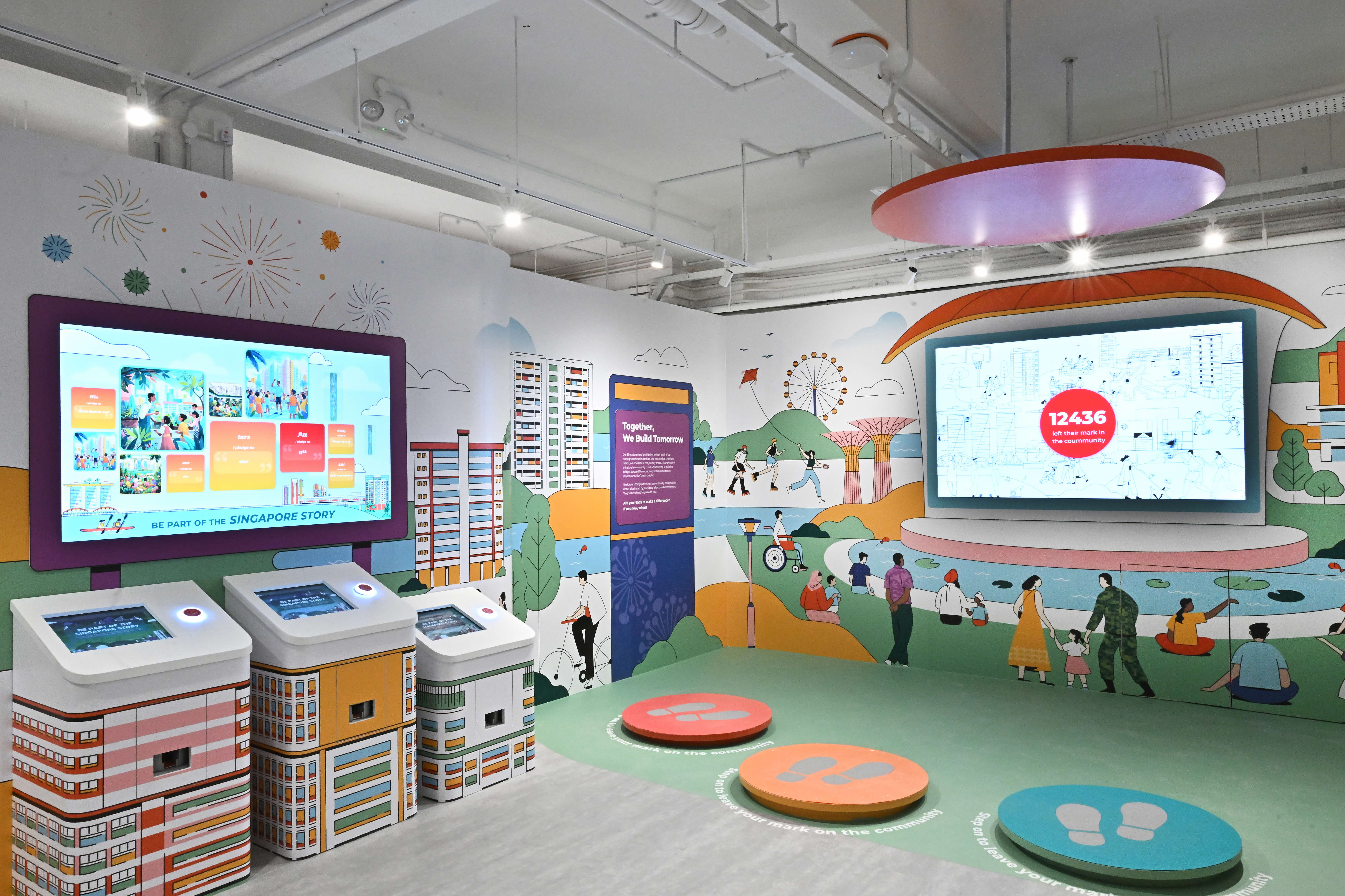 An interactive exhibit displaying screens and colorful illustrations of people, buildings, and landmarks in Singapore.