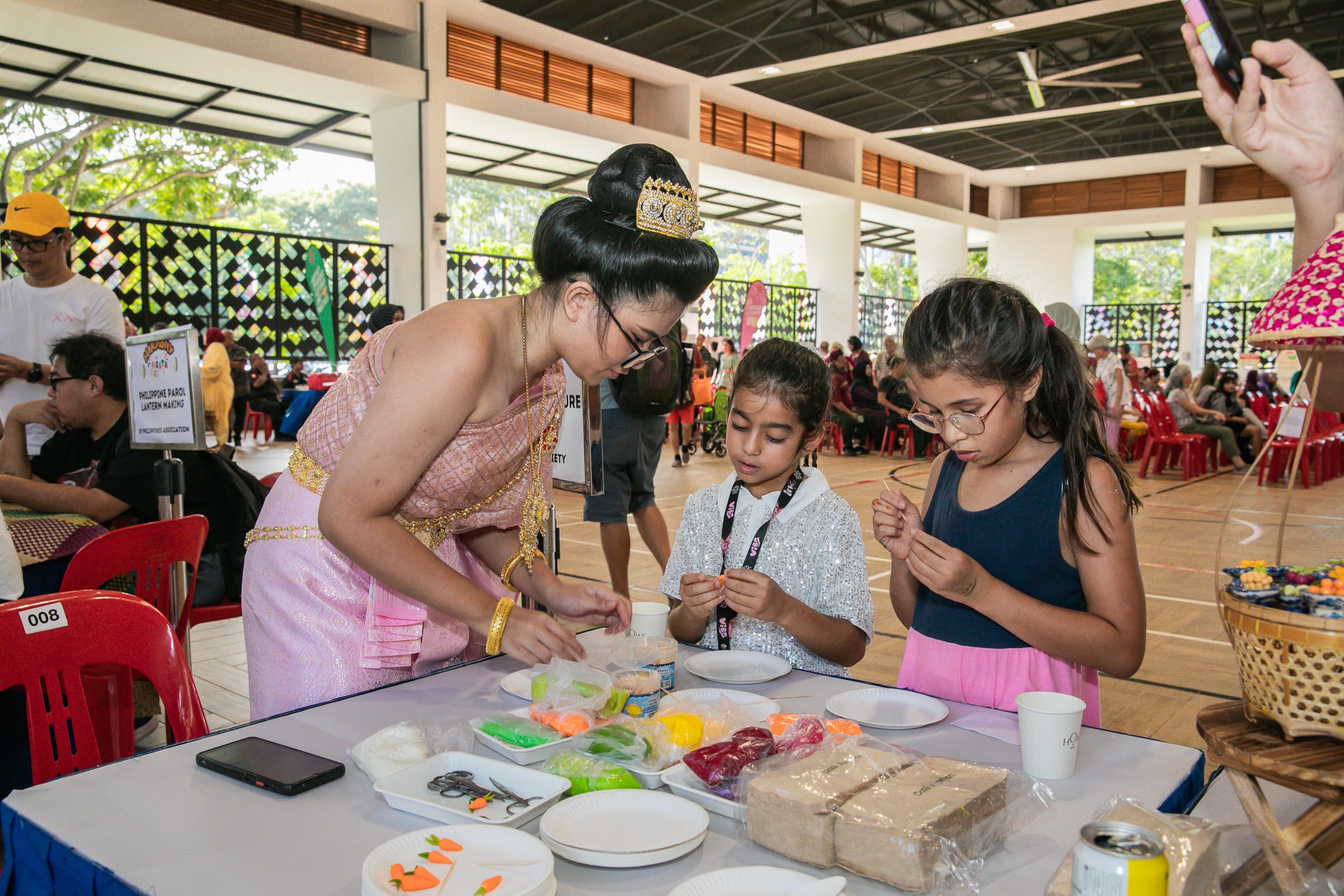 Two young girls enjoy learning more about thai desserts