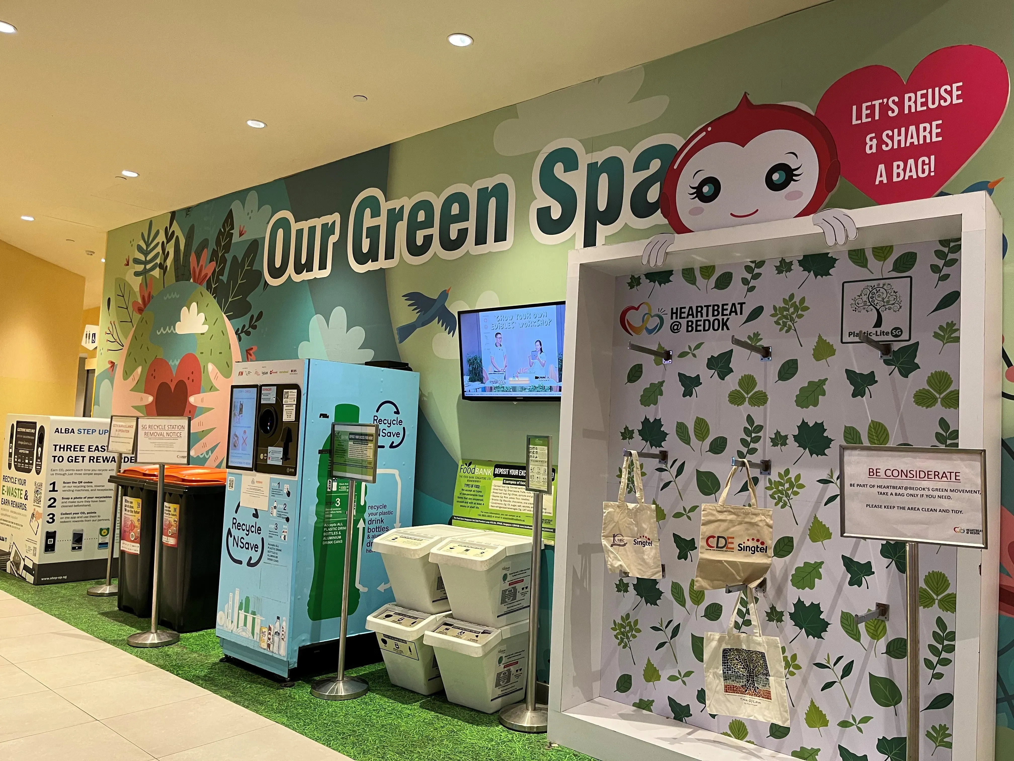 Our Green Space recycling station with bottle return machines and reusable bag display