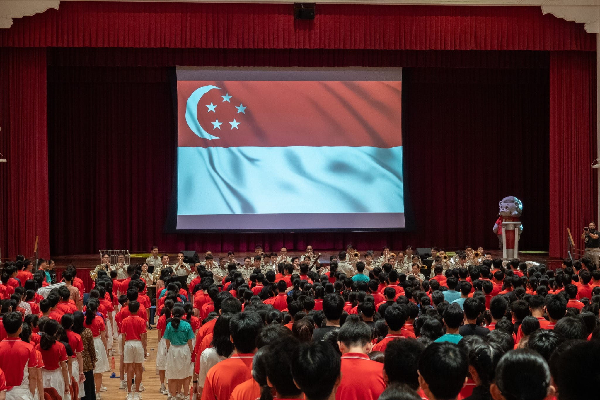 Students and staff participating in a rousing finale to the NE Outreach Programme with the National Anthem.