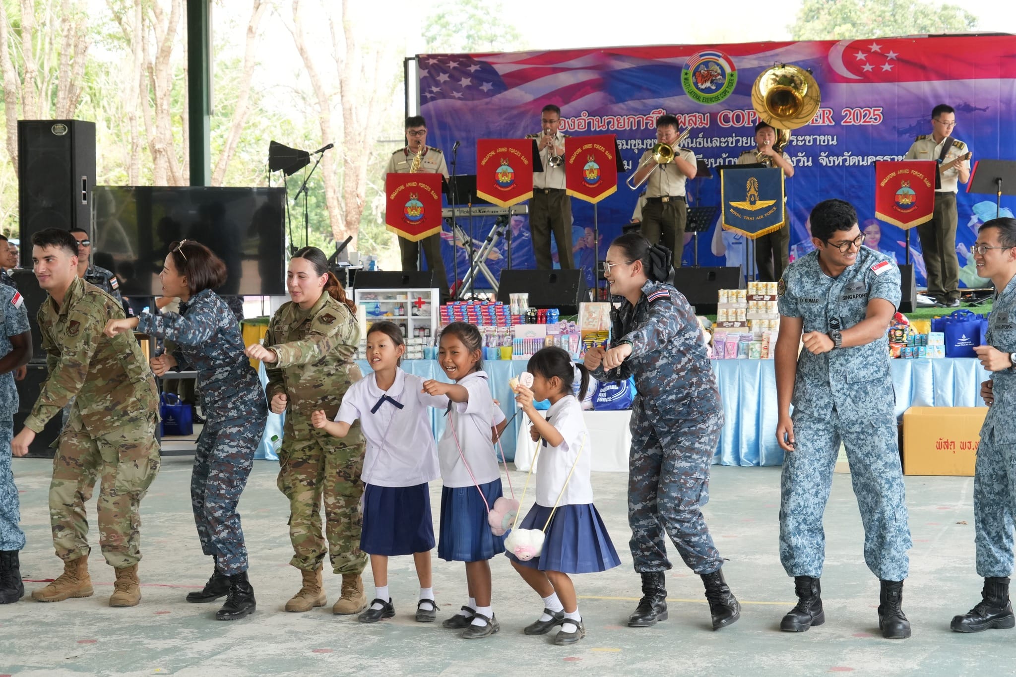 Organisers, musicians, and students sharing a lighthearted moment during the finale of the performance.