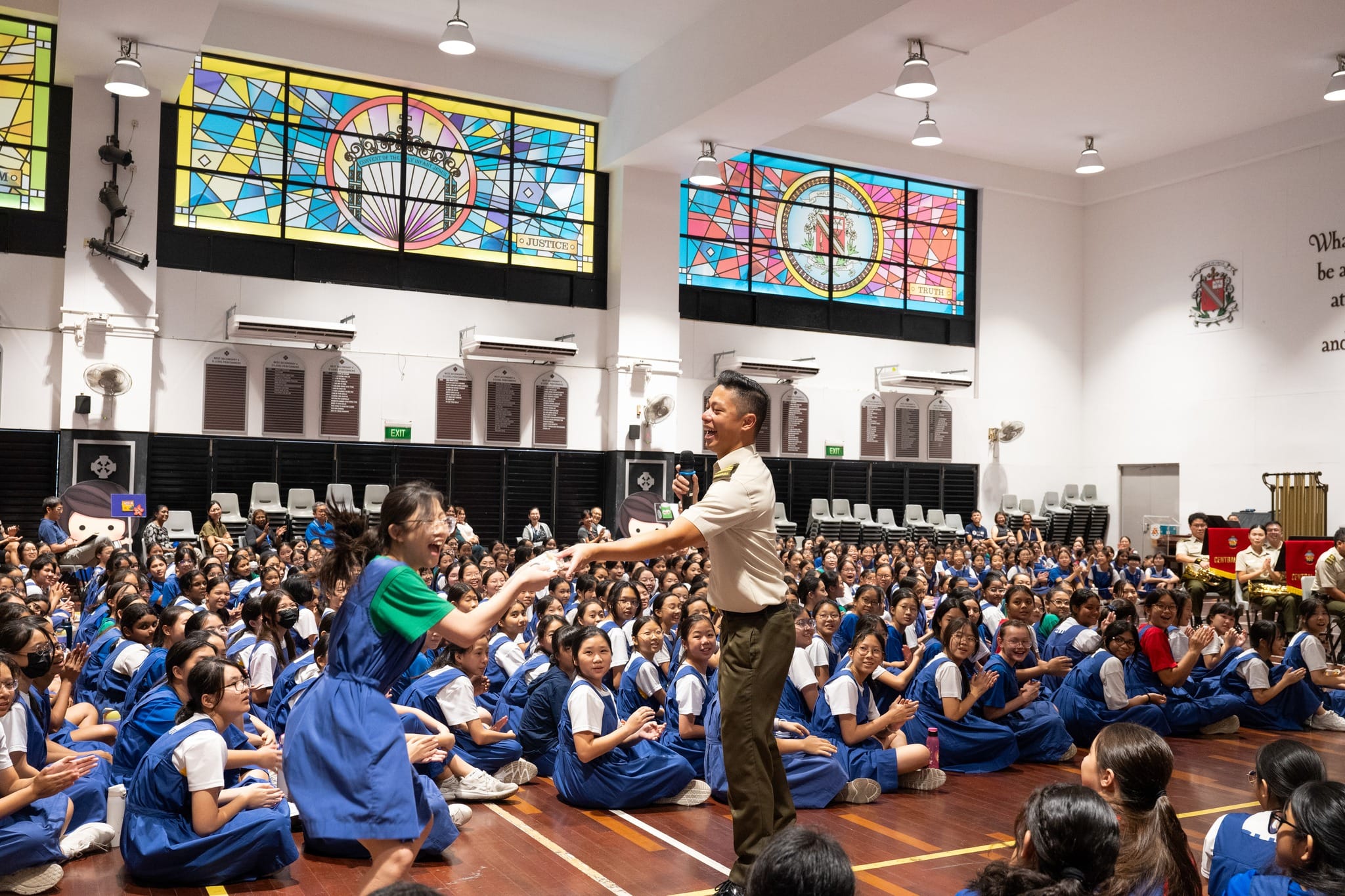 An elated student receiving exclusive merchandise after correctly answering a pop quiz question.