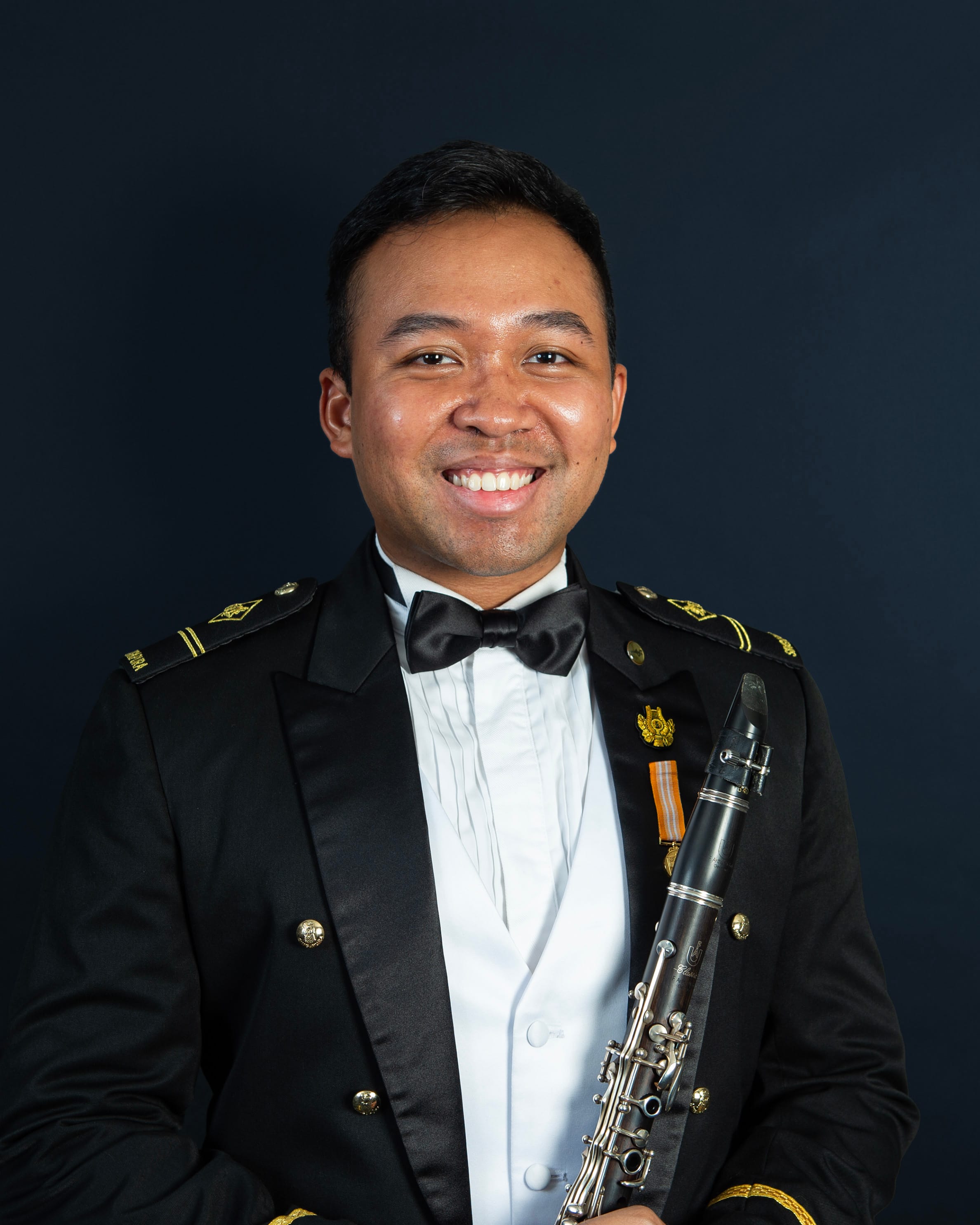 Portrait of ME2 Zulhafeez in uniform with a clarinet.
