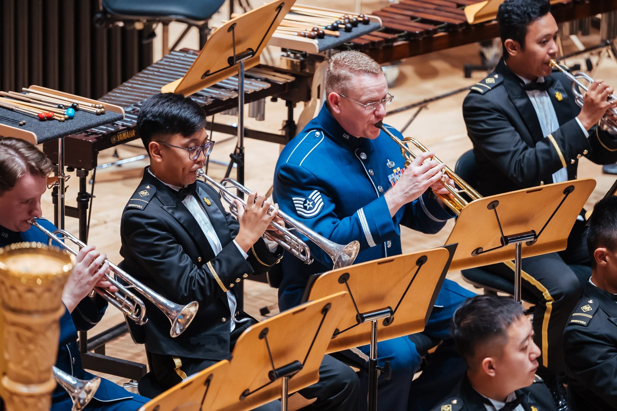 SrA Jonah Kelly (left) and TSgt Daniel Thrower (right) in performance with ME1 Foong Jun Yu.