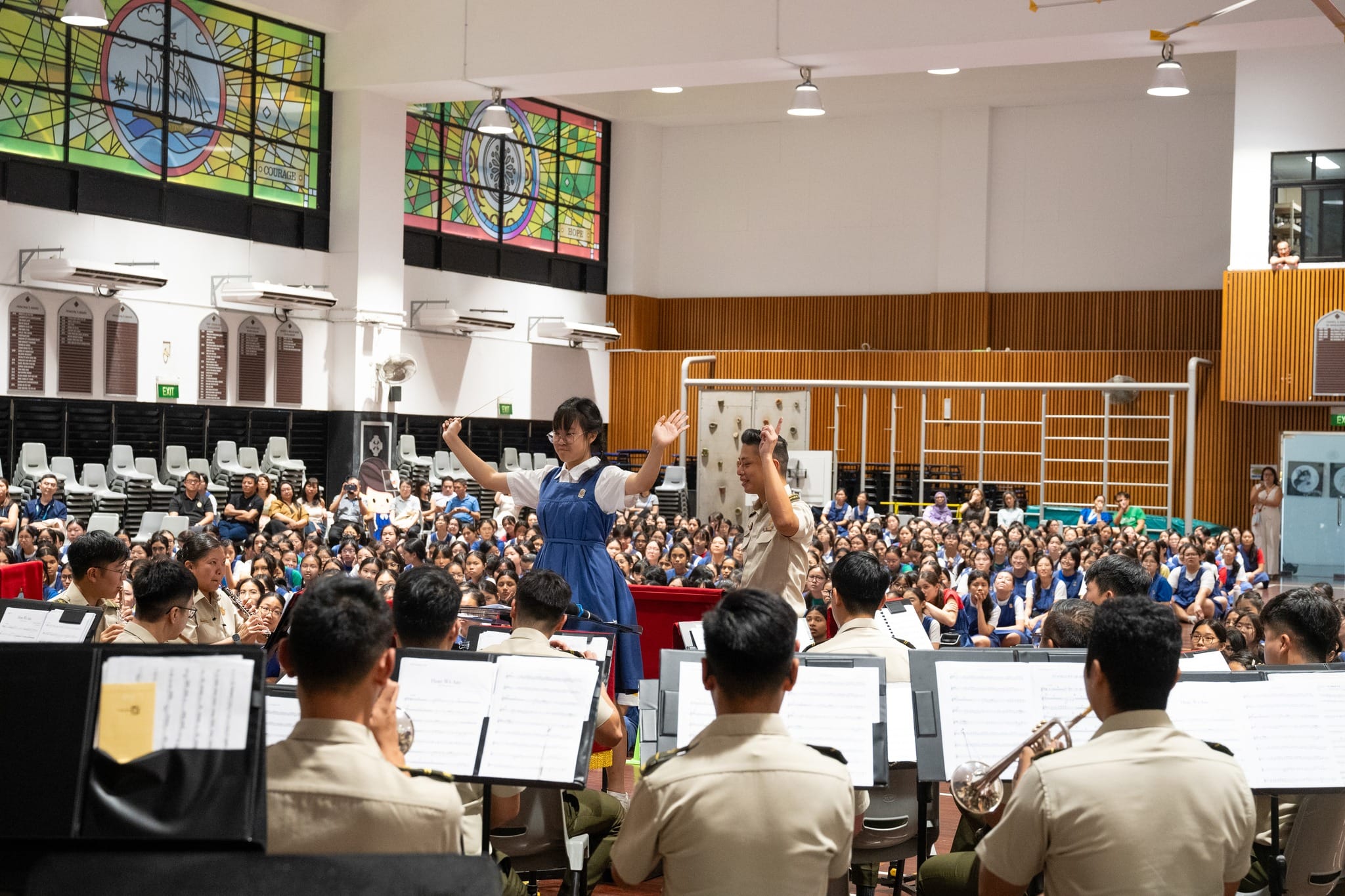 Student conductor of CHIJ Secondary School Concert Band Piriyaporn Phompiriya leading the SAF Central Band.