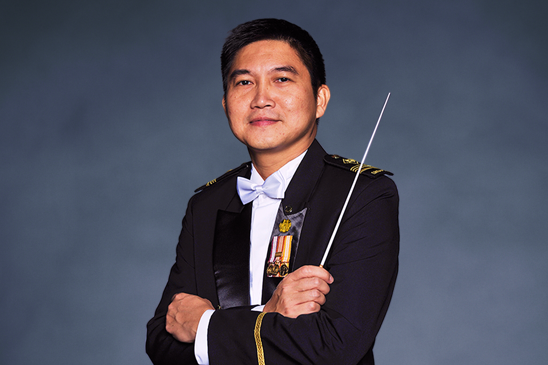 Portrait of ME6 Philip Tng in mess dress uniform with baton, featured on the SAF Central Band website.