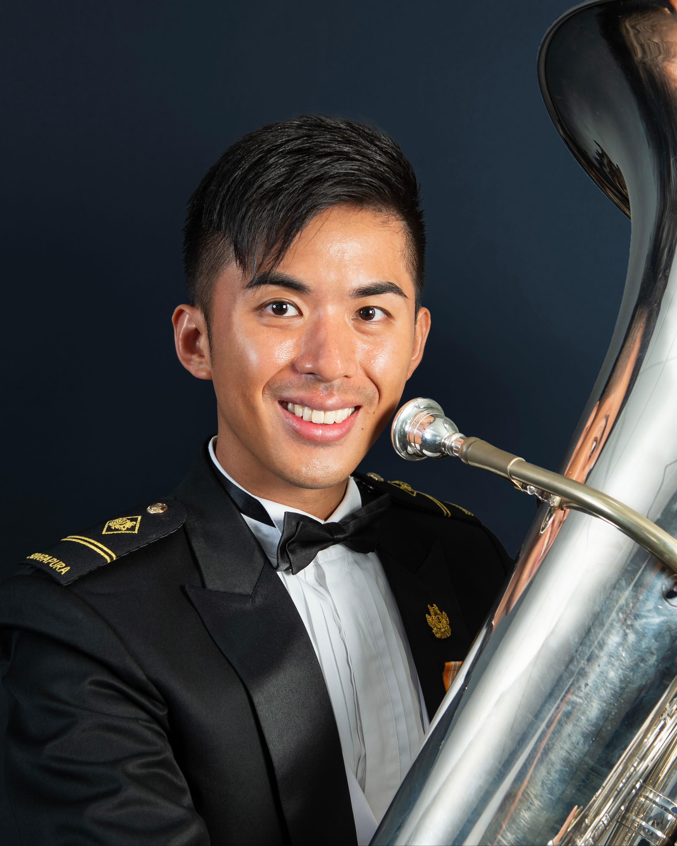 Portrait of ME2 Kendrick in uniform with a tuba.