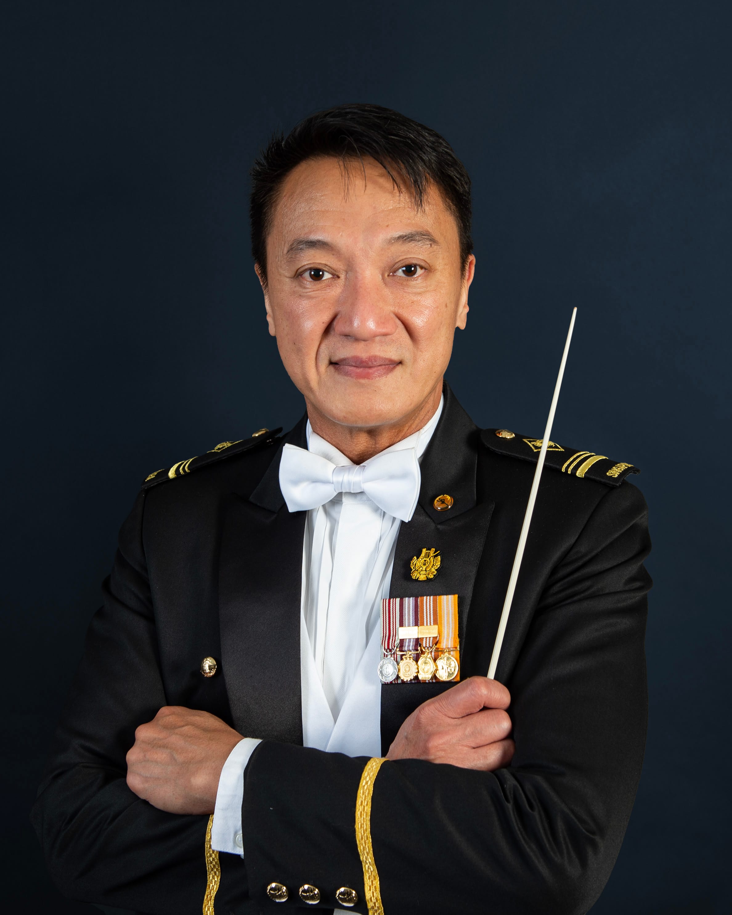 Portrait of ME5 Steven Tan in mess dress uniform with baton, featured on the SAF Central Band website.