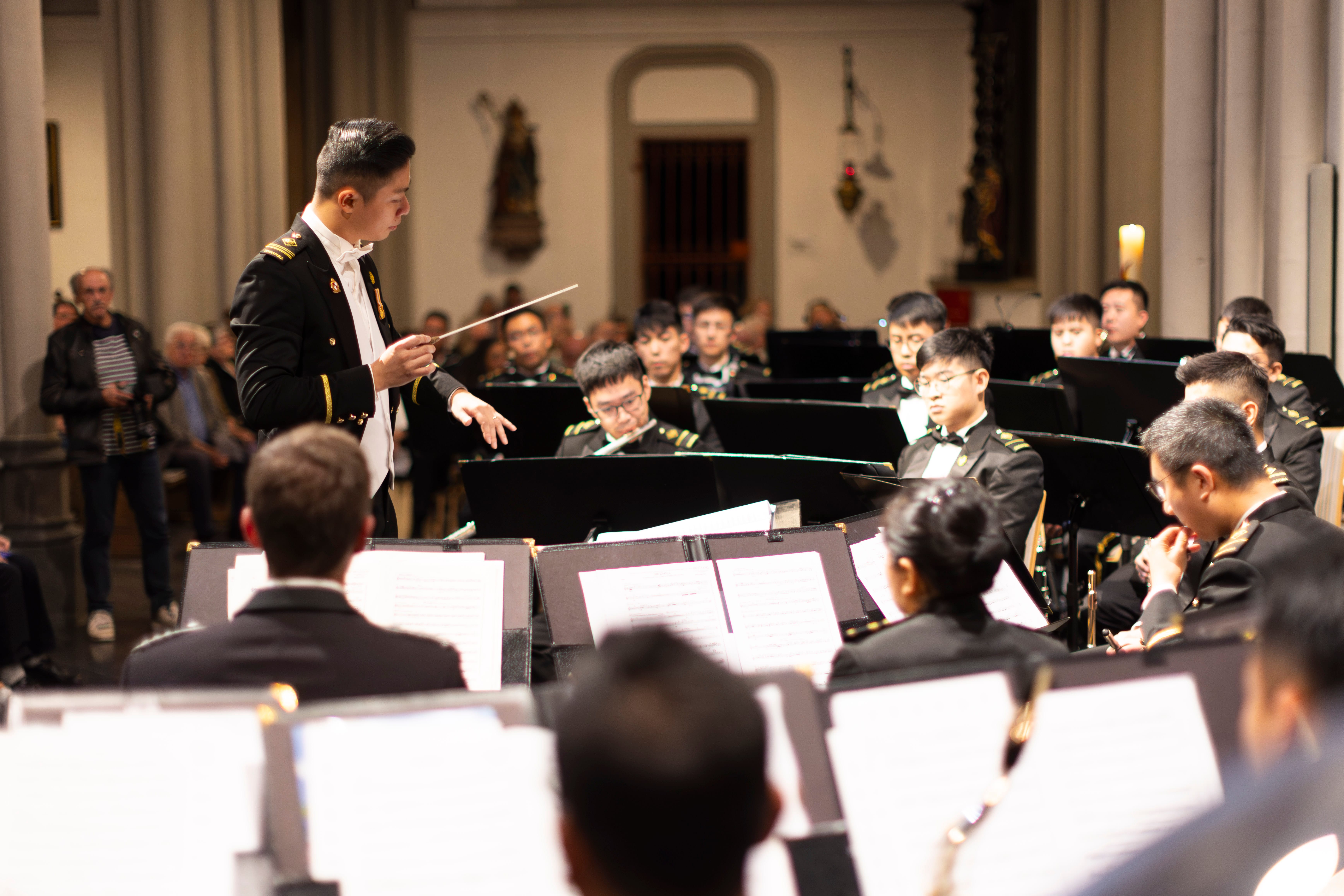 SAF Central Band performs in concert with conductor leading in a European cathedral setting.