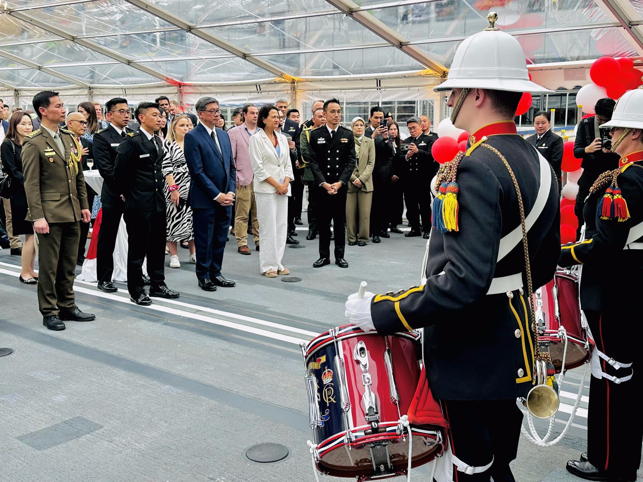 Honorary guests receiving a salute from the RM Corps of Drums at the opening.
