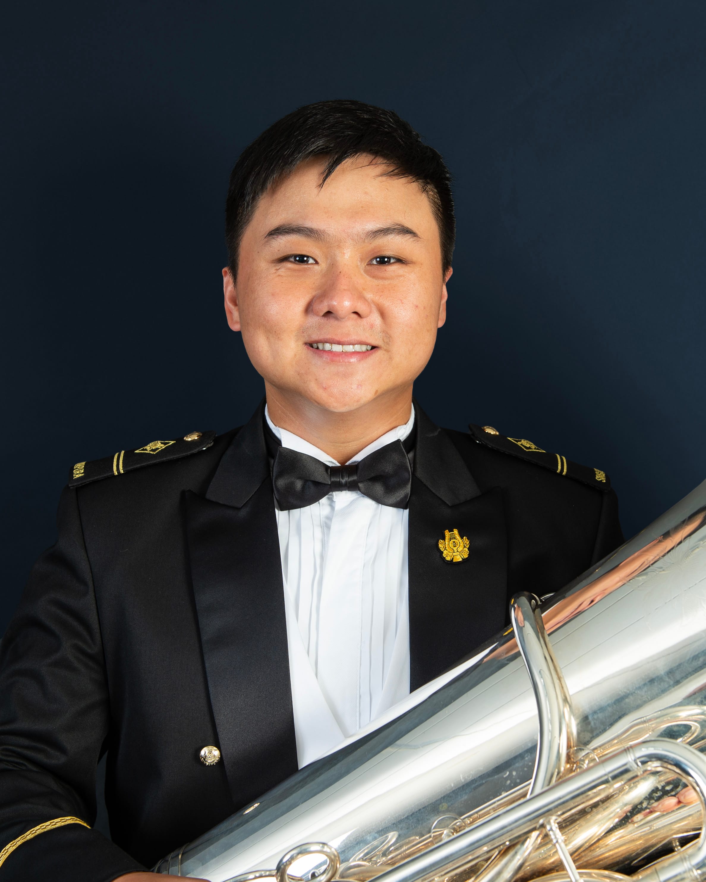 Portrait of ME2 Shawn Yap Jiaq in uniform with a tuba.