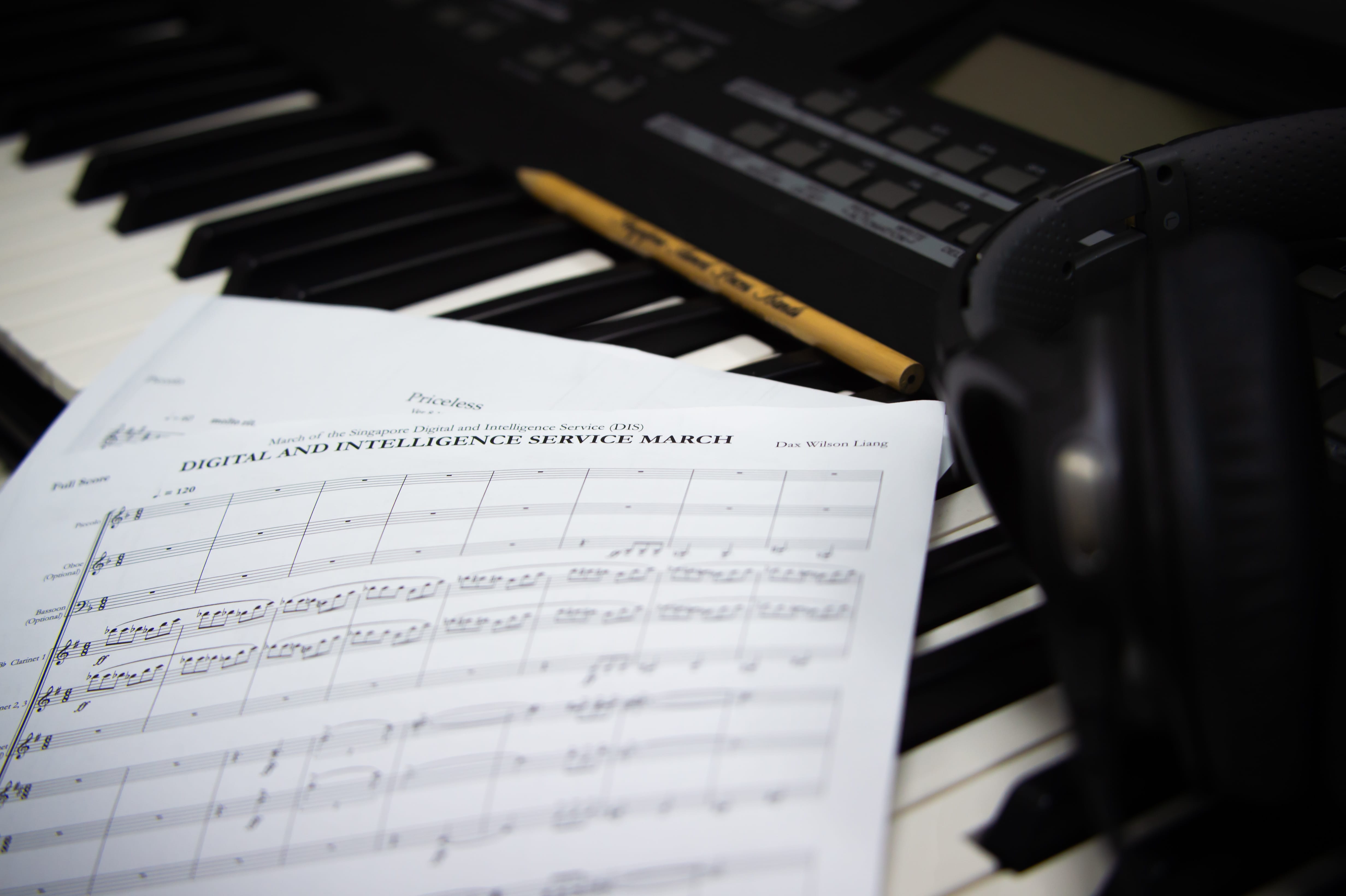 Image from the composition studio with scores, pencil, and piano