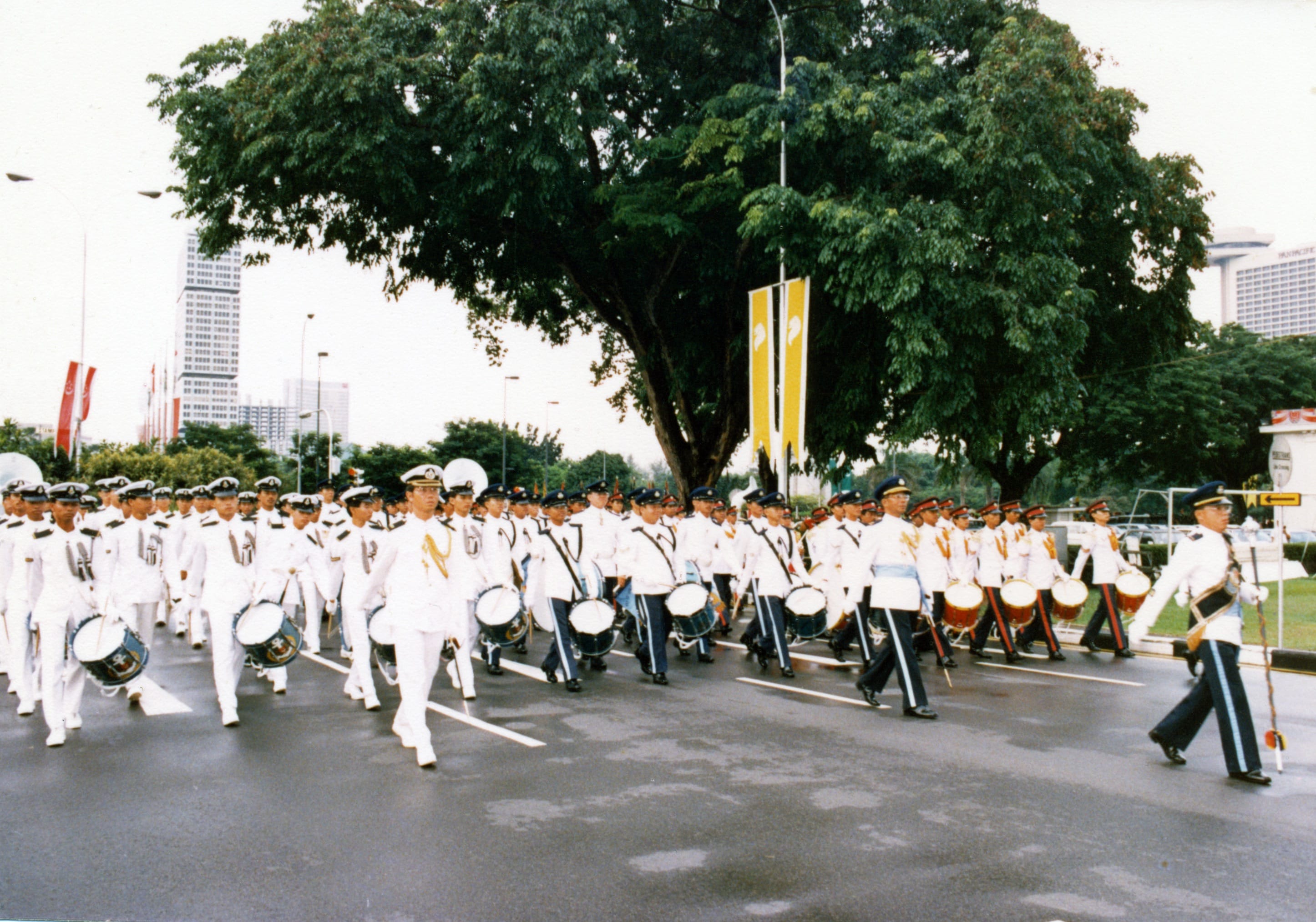 SAF Band marching in formation at a National Day Parade in the civic district.