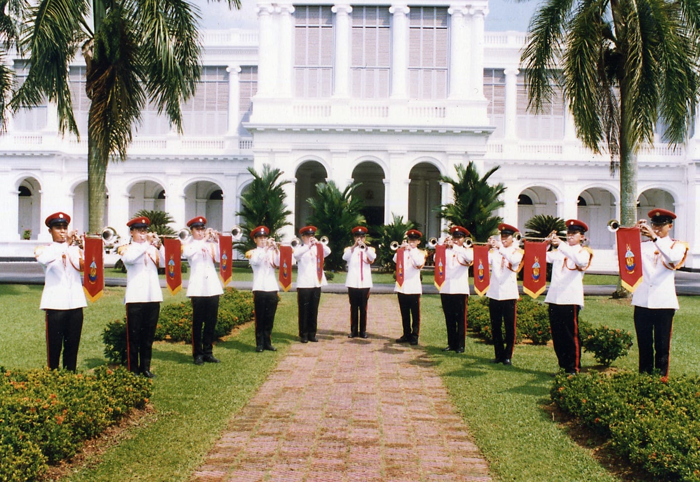 SAF fanfare trumpeters performing on the grounds of the Istana in ceremonial uniform.