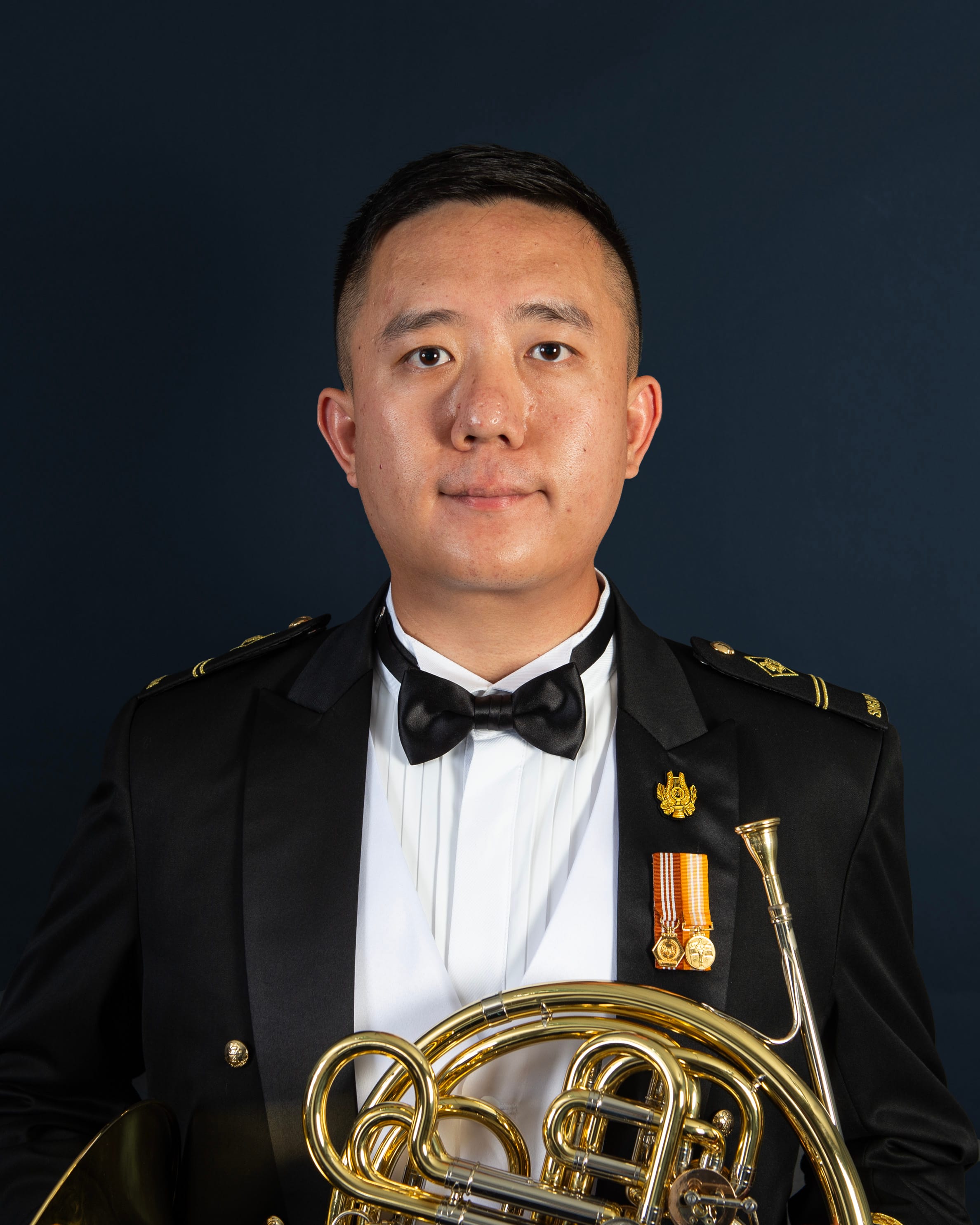 Portrait of ME2 Lewis in uniform with a french horn.