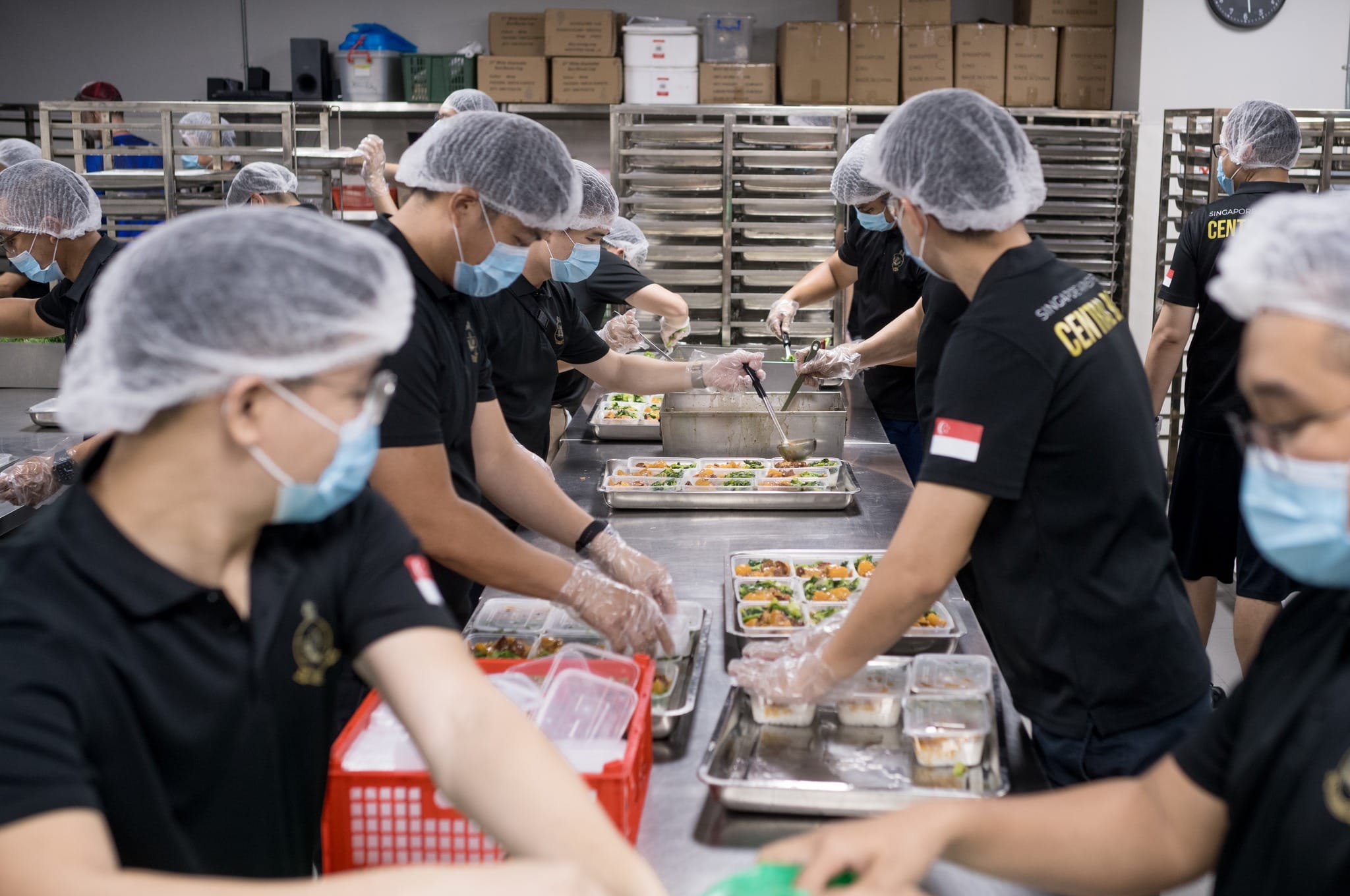 Musicians of the SAF Central Band assisting with food packing.