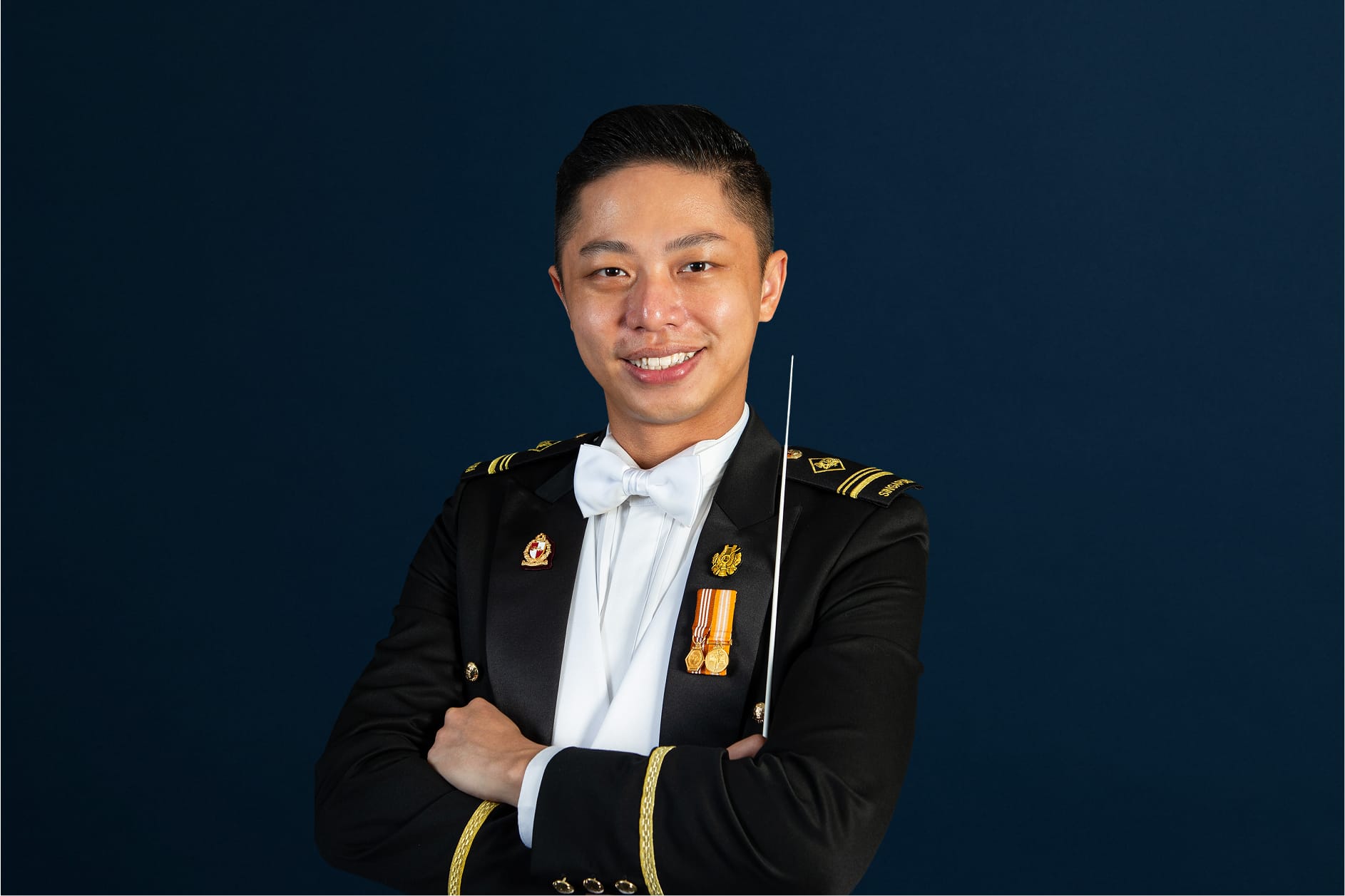 Portrait of ME5 Ignatius Wang in mess dress uniform with baton, featured on the SAF Central Band site.