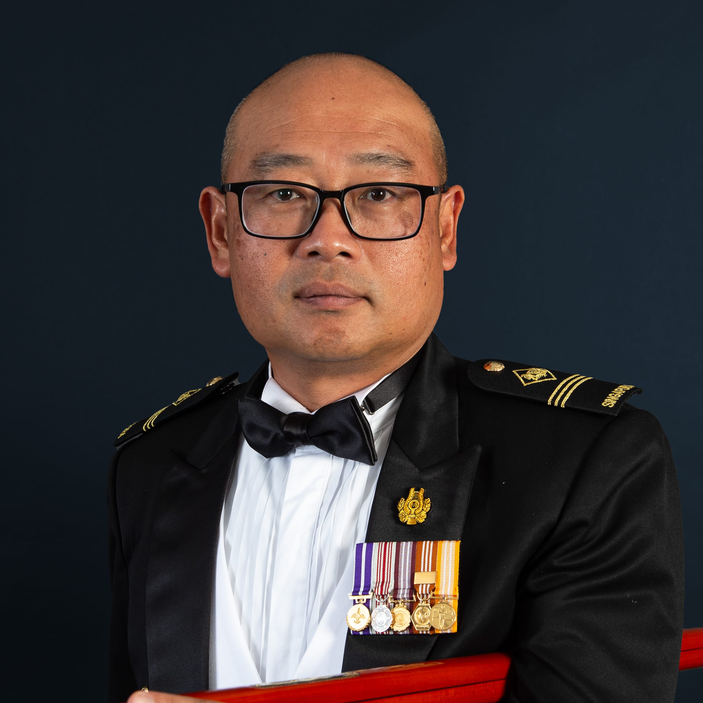 Portrait of ME3 Lim Wee Beng Gilbert in mess dress uniform with pace stick