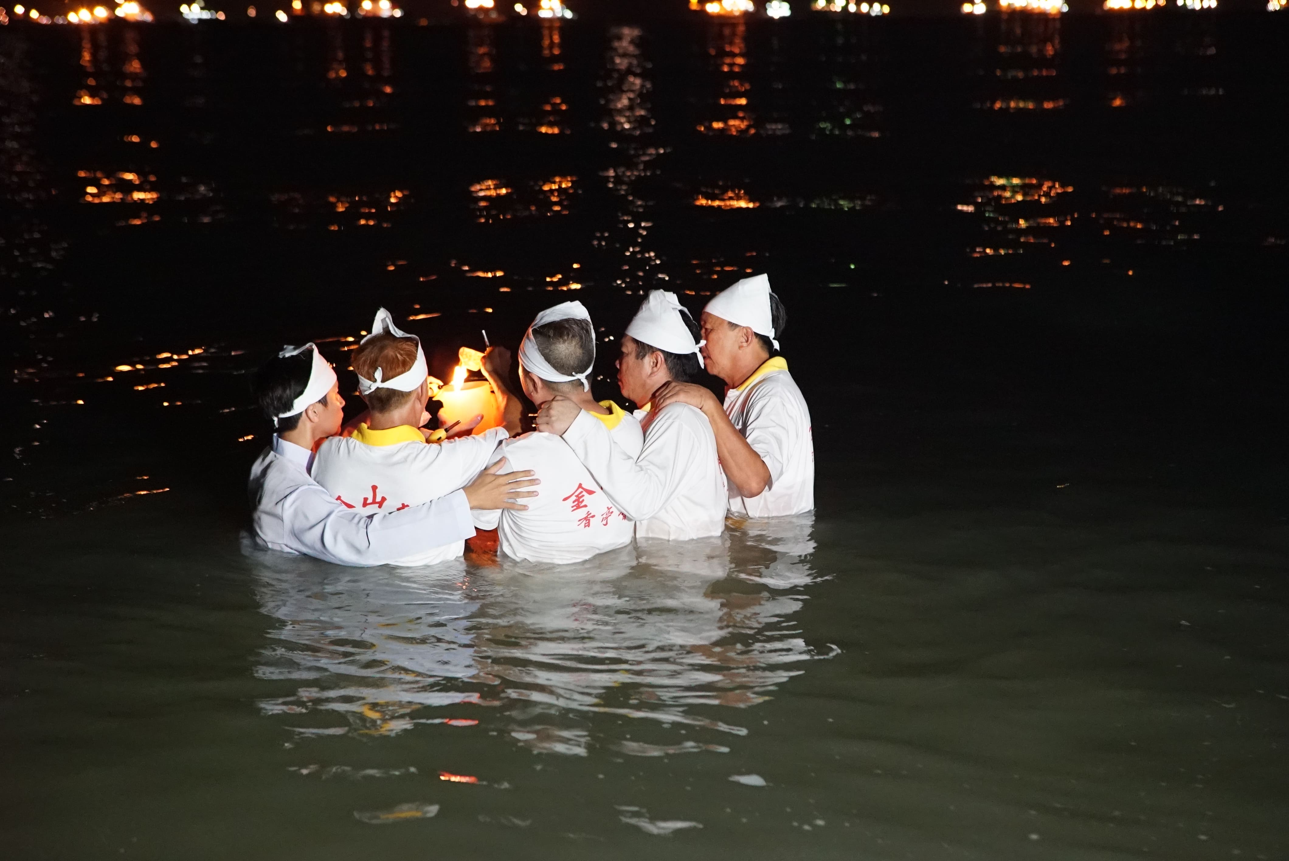 Jin Shan Si devotees collect sea water as part of the receiving ceremony of the Nine Emperor God