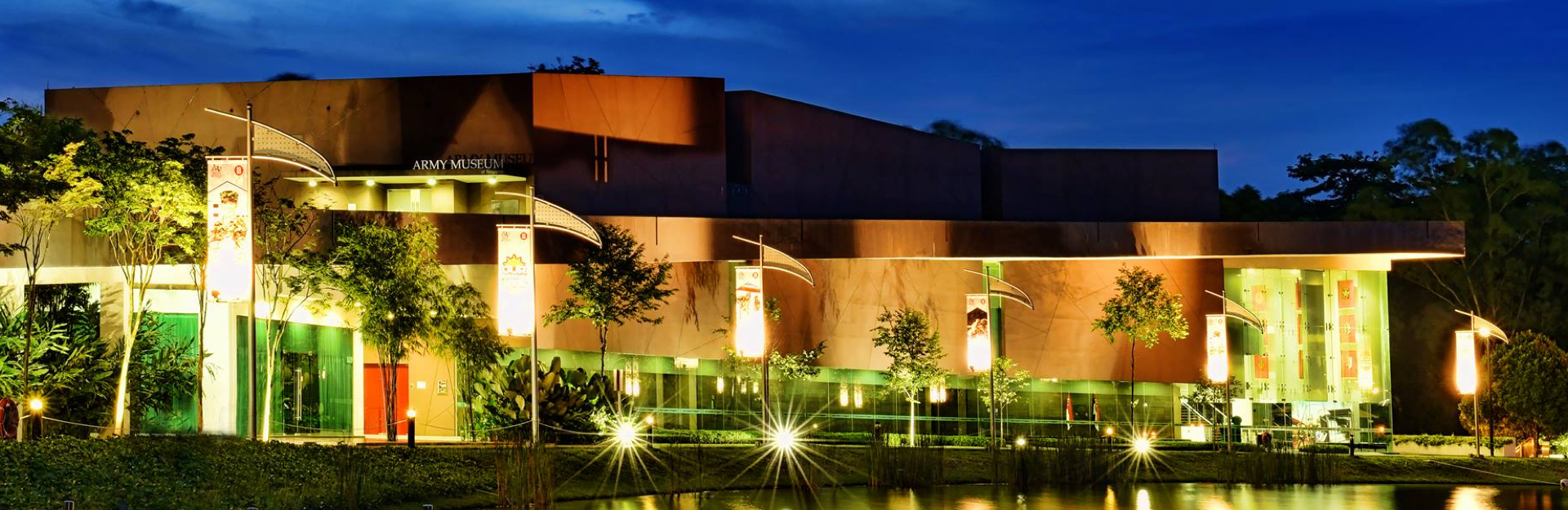 The Army Museum building illuminated at night, showcasing its modern architecture.