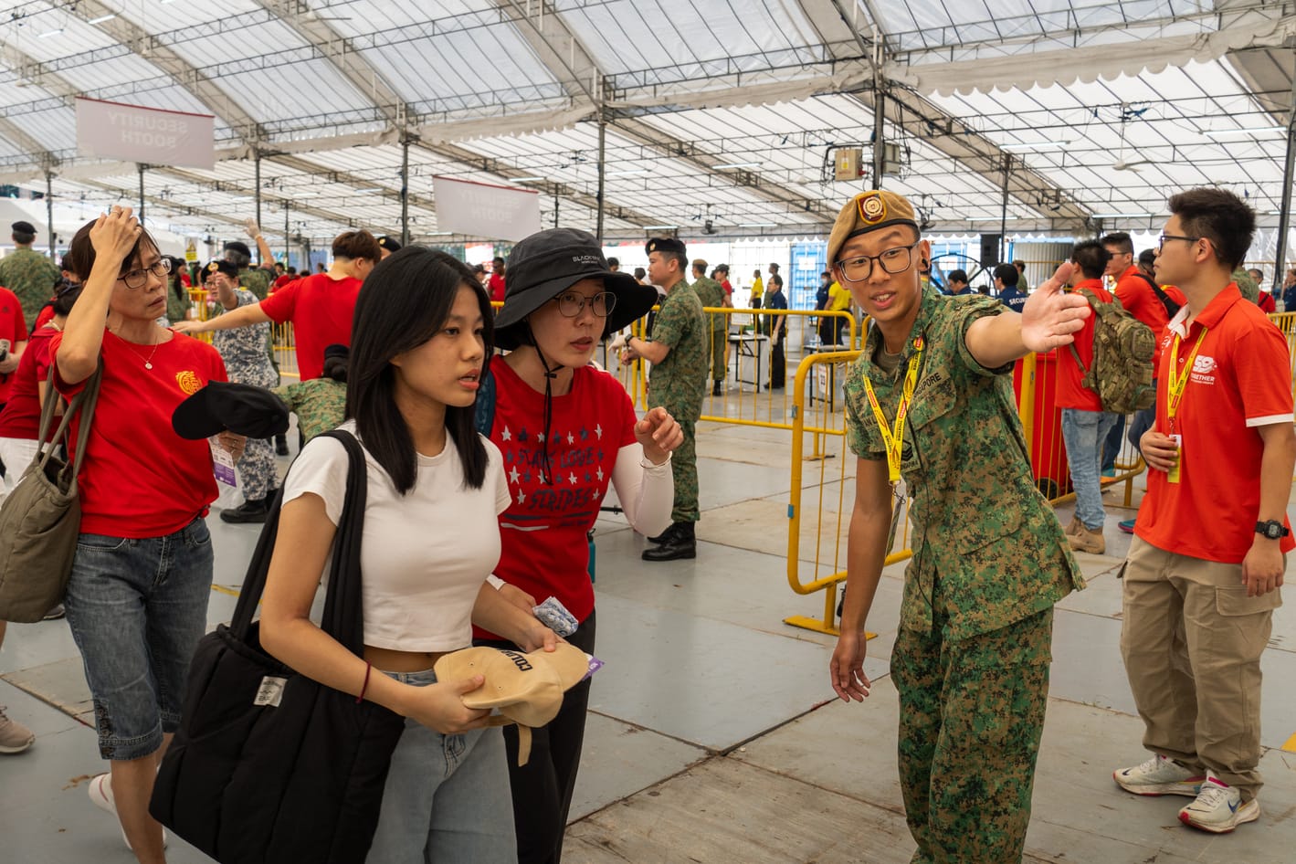 SAF soldier assisting NDP visitors at the entrance checkpoint.