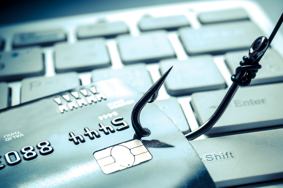 Credit card on a hook, symbolizing phishing attacks in digital security.