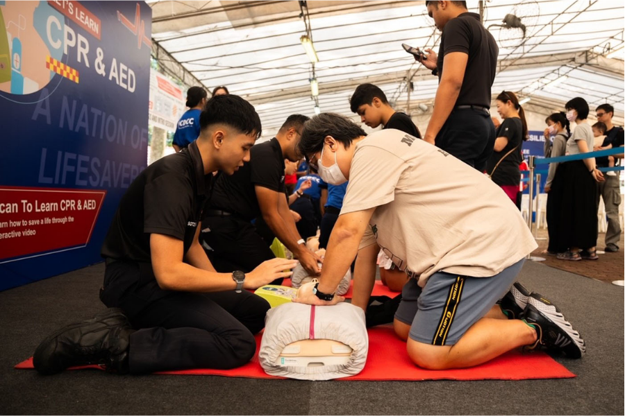 Participants learning CPR and AED techniques during a community training session.