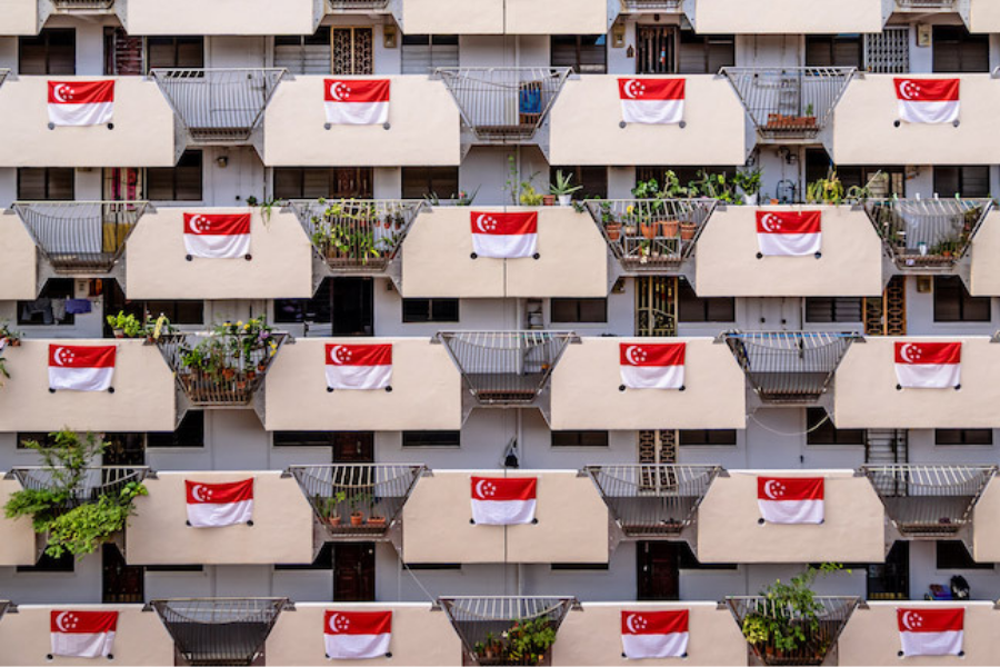 Singaporean HDB balconies adorned with national flags showcasing patriotism.