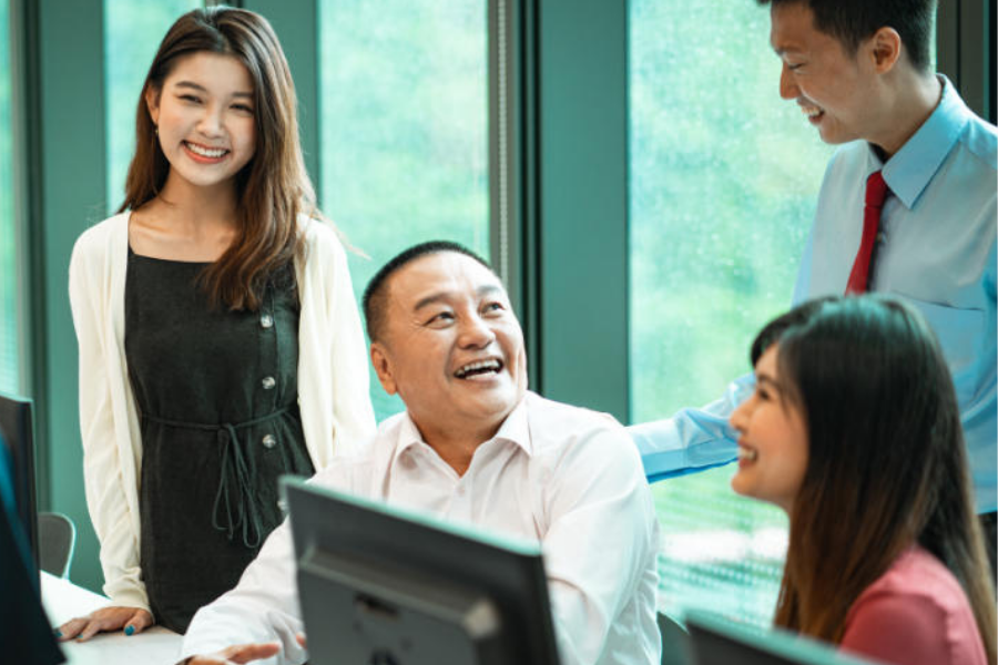 A diverse group of professionals engaged in a lively discussion in an office environment.