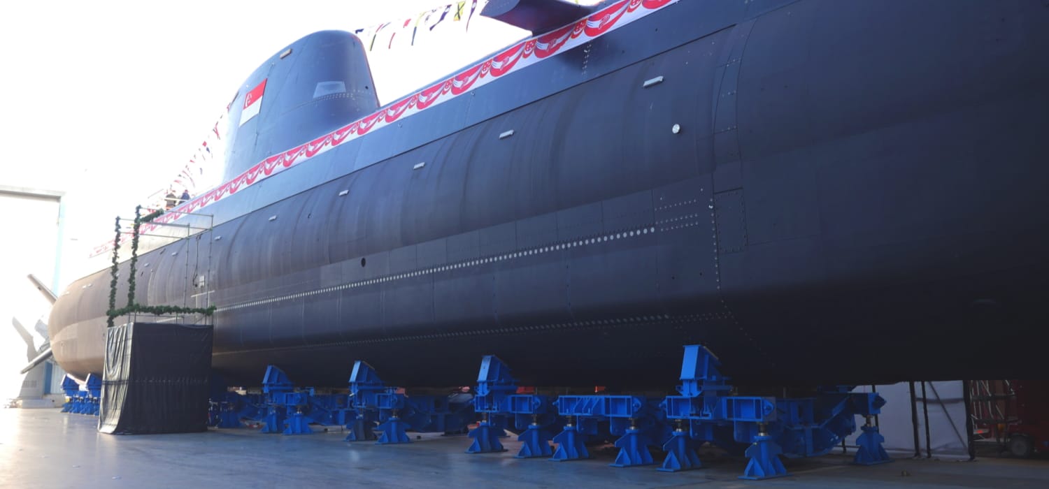 Invincible-class submarine on land display with Singapore flags and banners