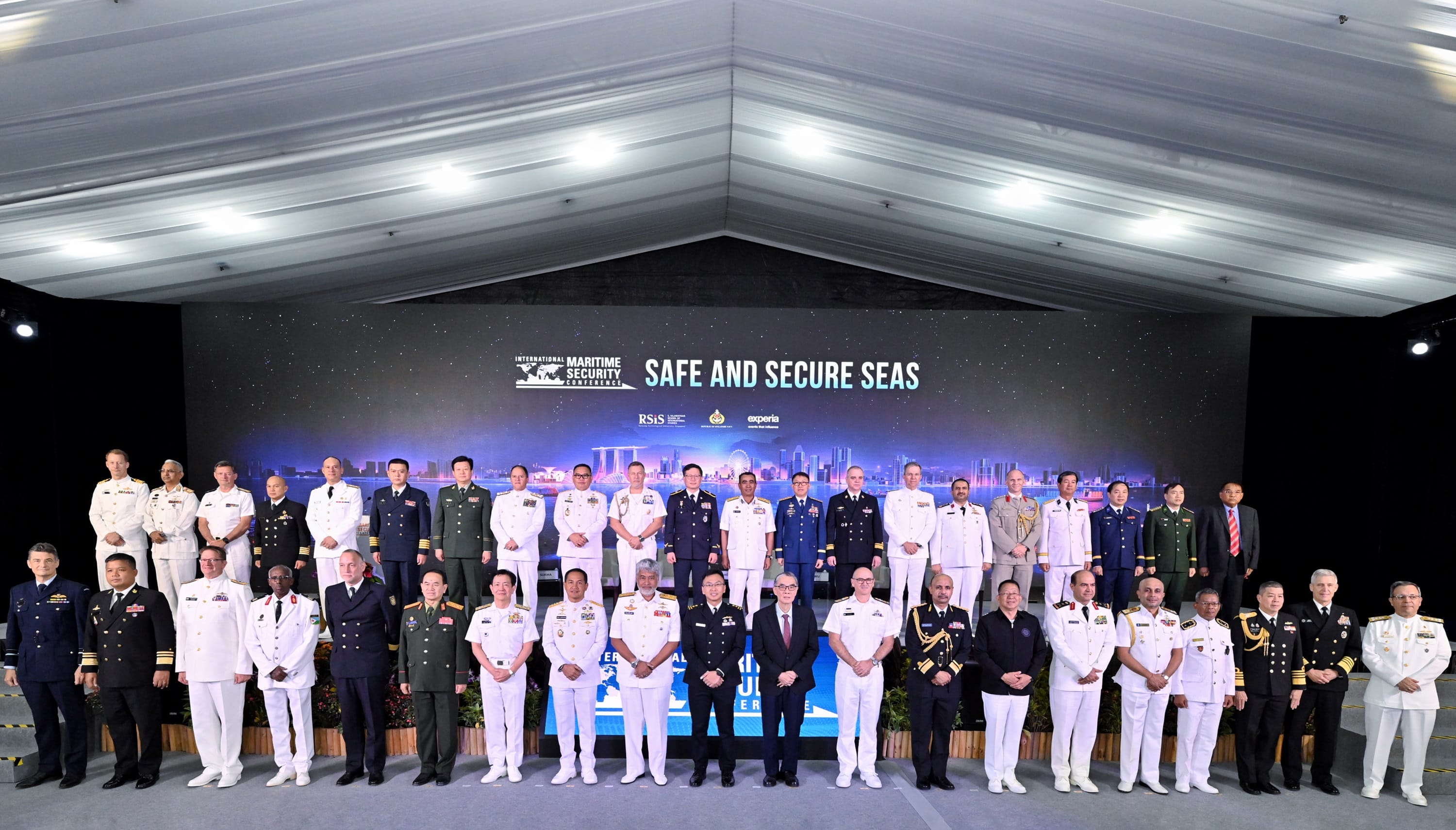 Delegates in uniform pose on stage at the International Maritime Security Conference 2025.