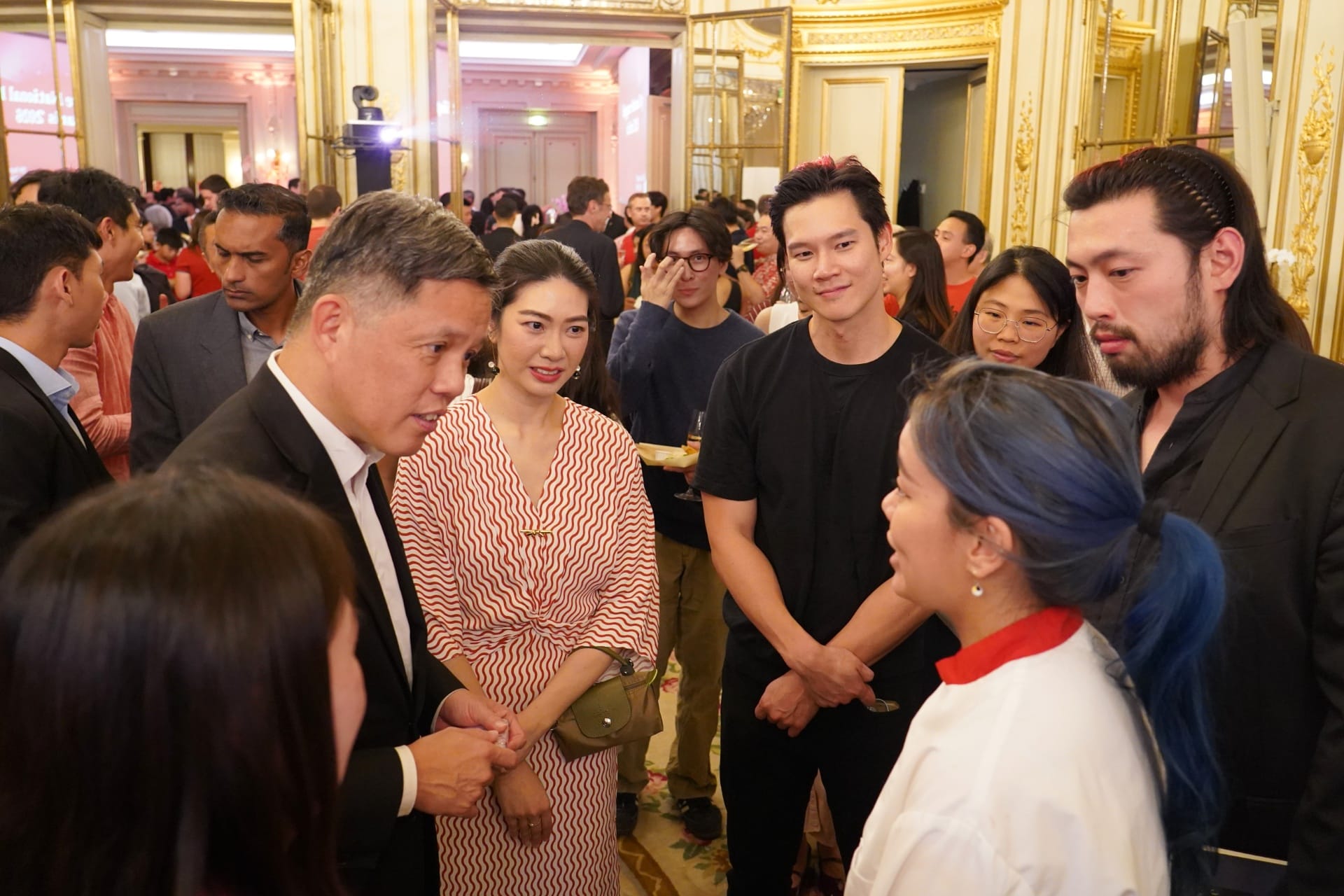 Minister Chan interacting with Singaporeans at a National Day Reception held in Paris.