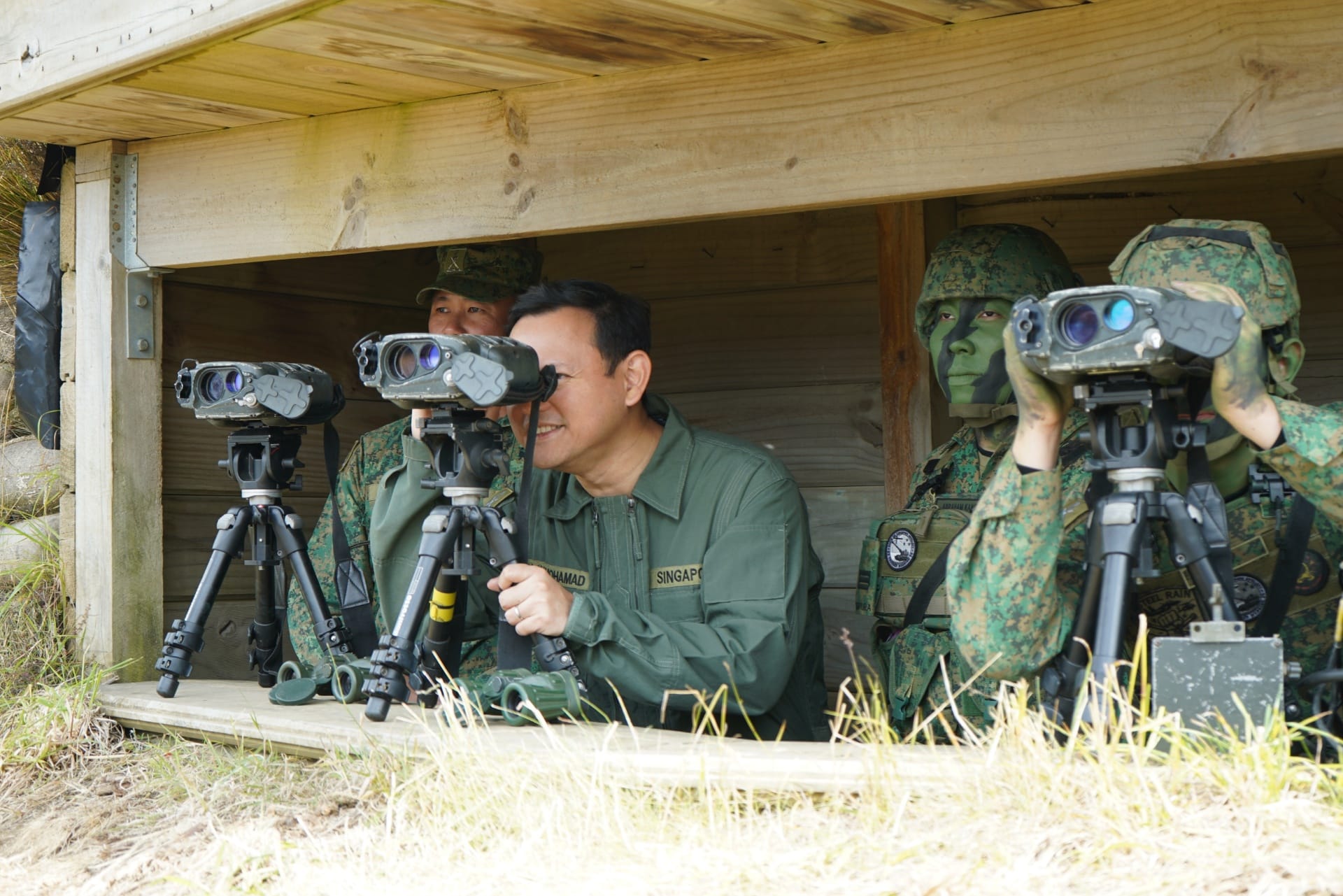 Mr Zaqy (second from left) observing the impact area of the Singapore Self-Propelled Howitzer (SSPH) live firing from the observation post.
