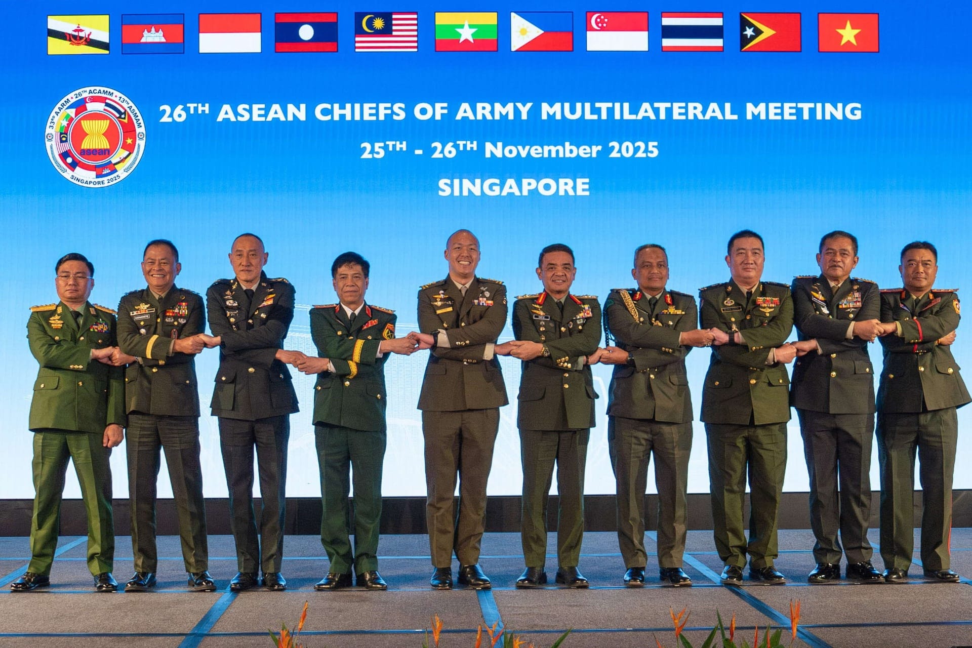 MG Cai (fifth from left) taking part in the ASEAN handshake with the other ASEAN COAs at the ACAMM.