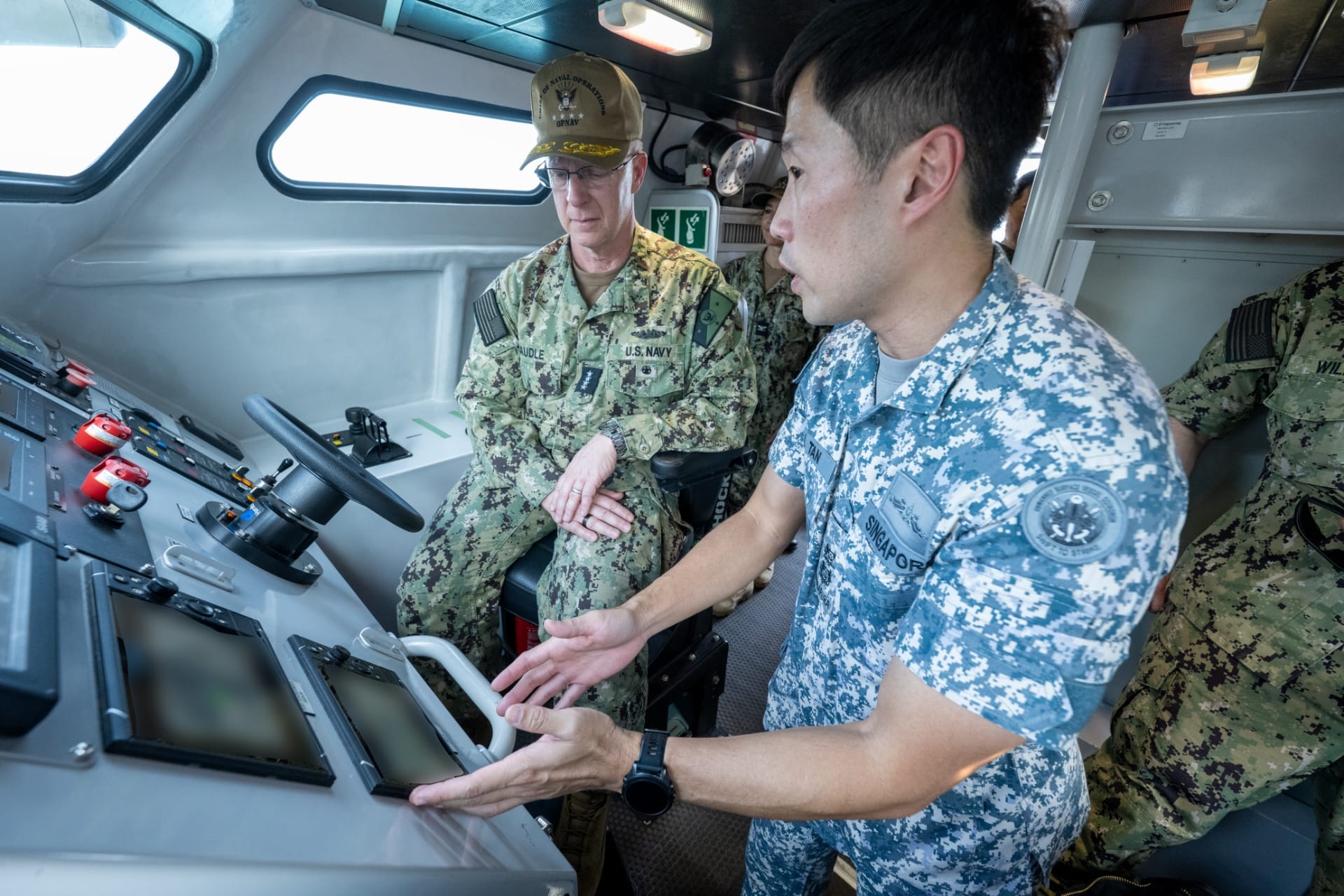 ADM Caudle (left) being briefed on the capabilities and deployments of the RSN’s Maritime Security Unmanned Surface Vessel.