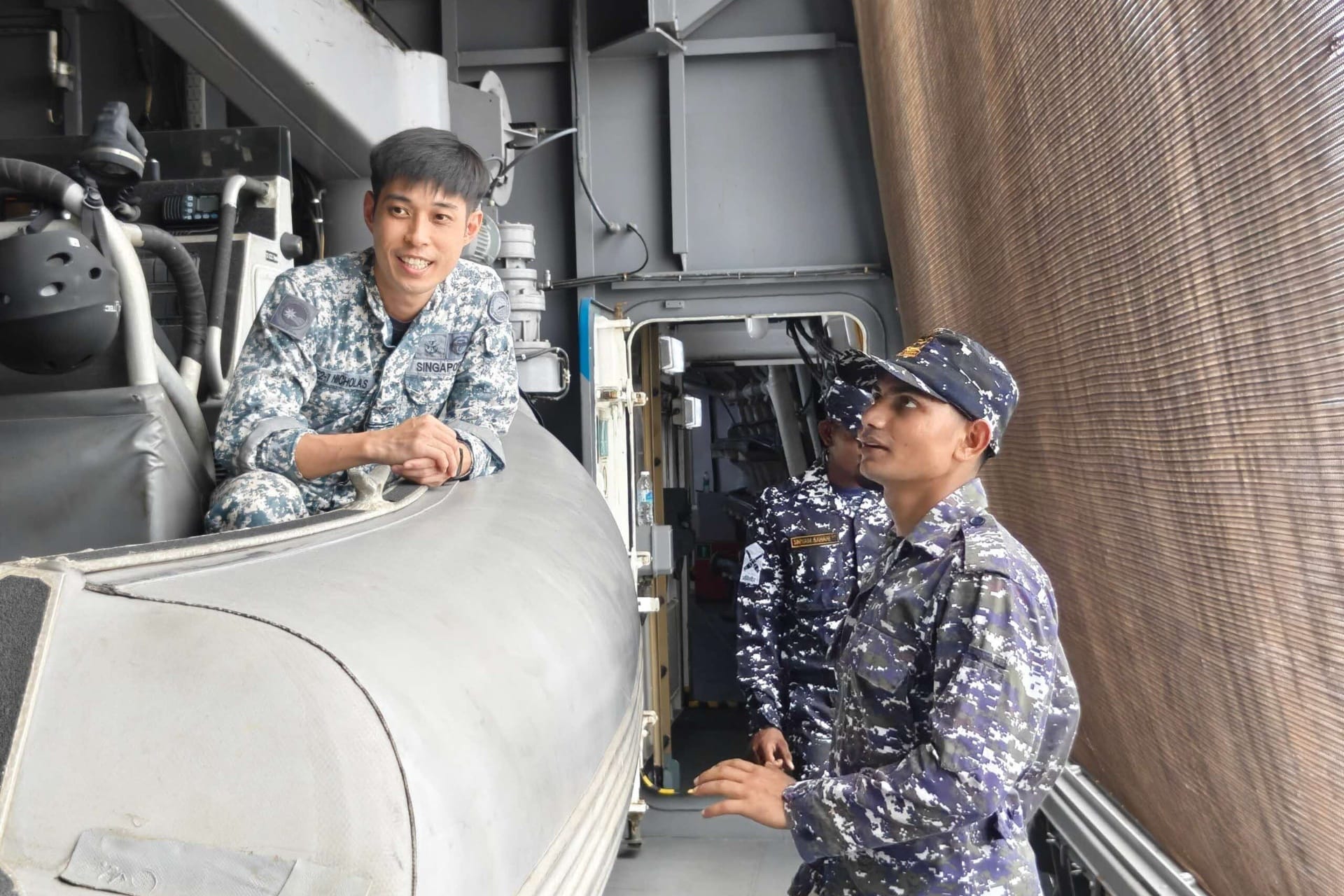 RSN personnel conducting a deck familiarisation brief for IN personnel aboard RSS Supreme.