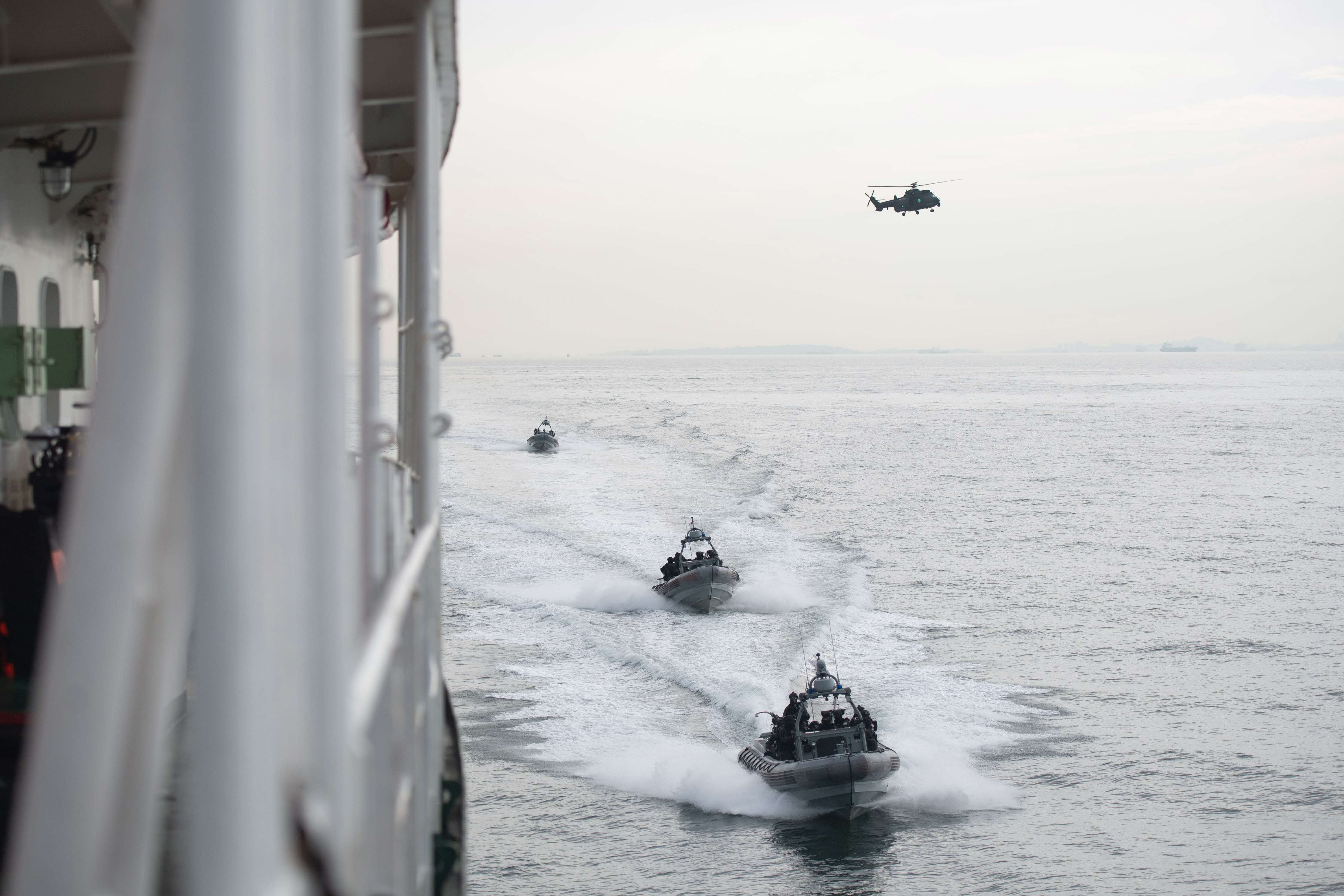The Singapore Armed Forces’ (SAF) H225M helicopter and Rigid-Hulled Inflatable Boats inserting Special Operations Task Force (SOTF) personnel via air and sea.