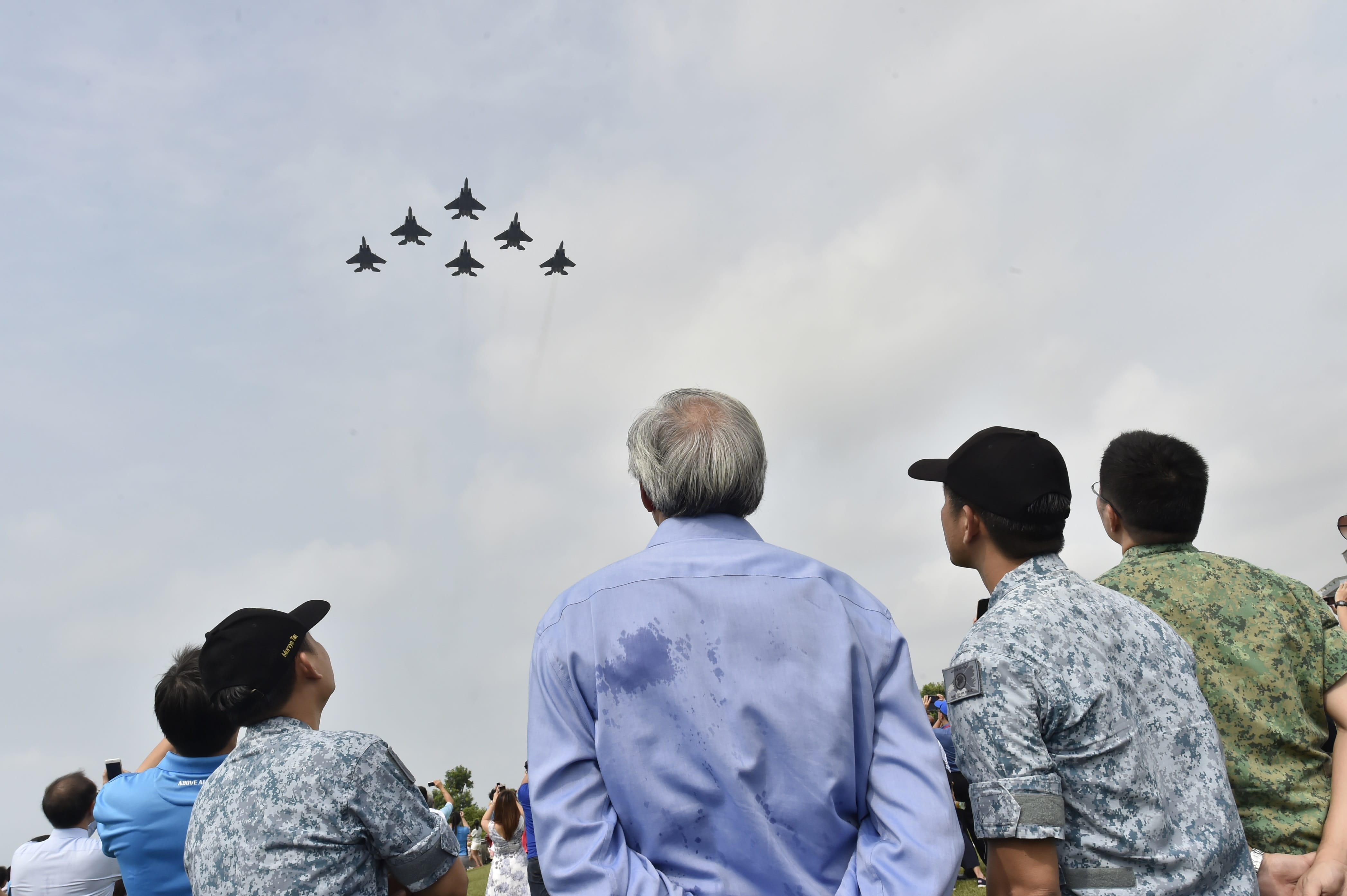 Minister for Defence Dr Ng Eng Hen (centre) viewing the flypast at the RSAF50 @ Marina Barrage preview event earlier this morning.