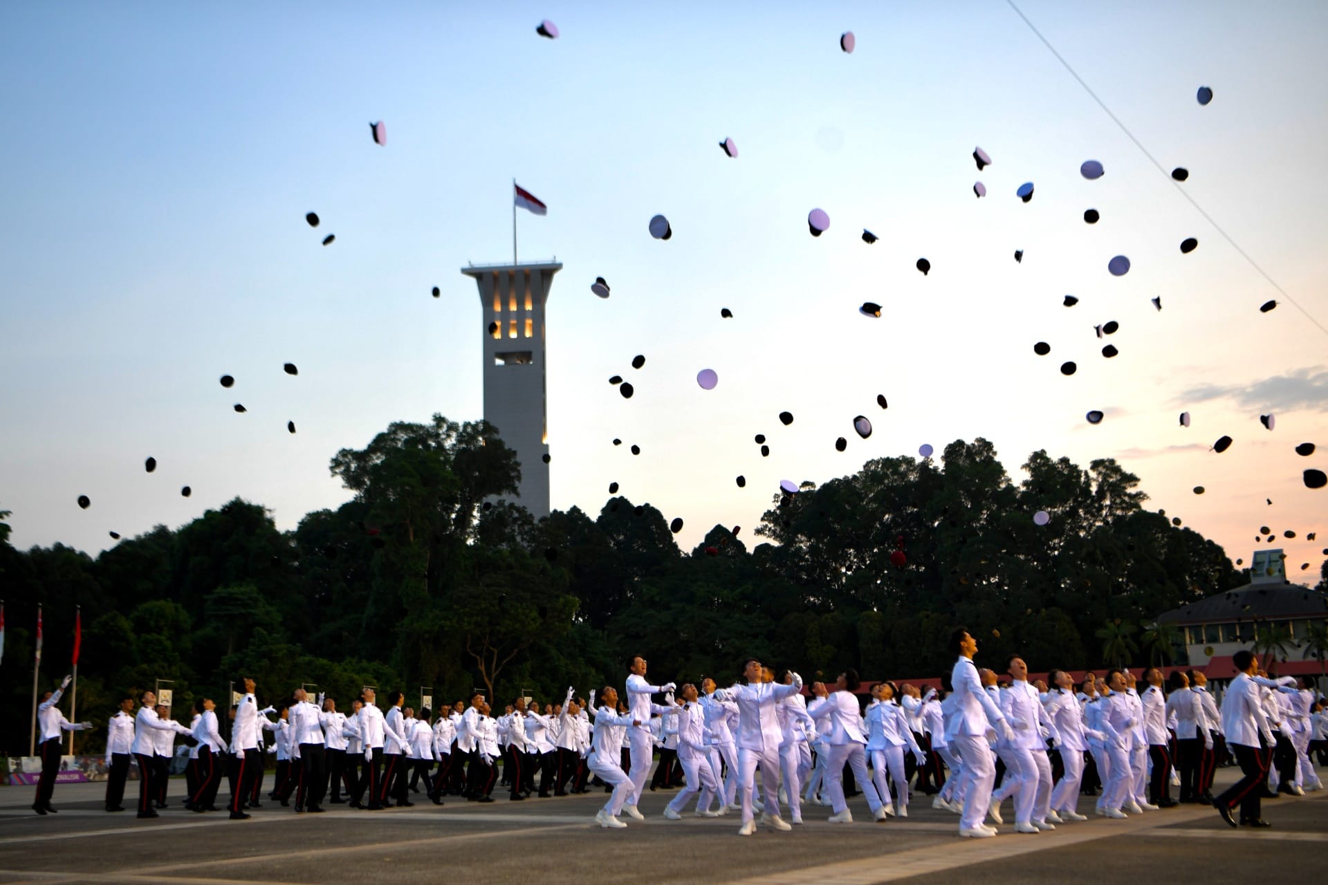 The newly commissioned officers tossing their headdresses to mark the completion of their 38-week course.