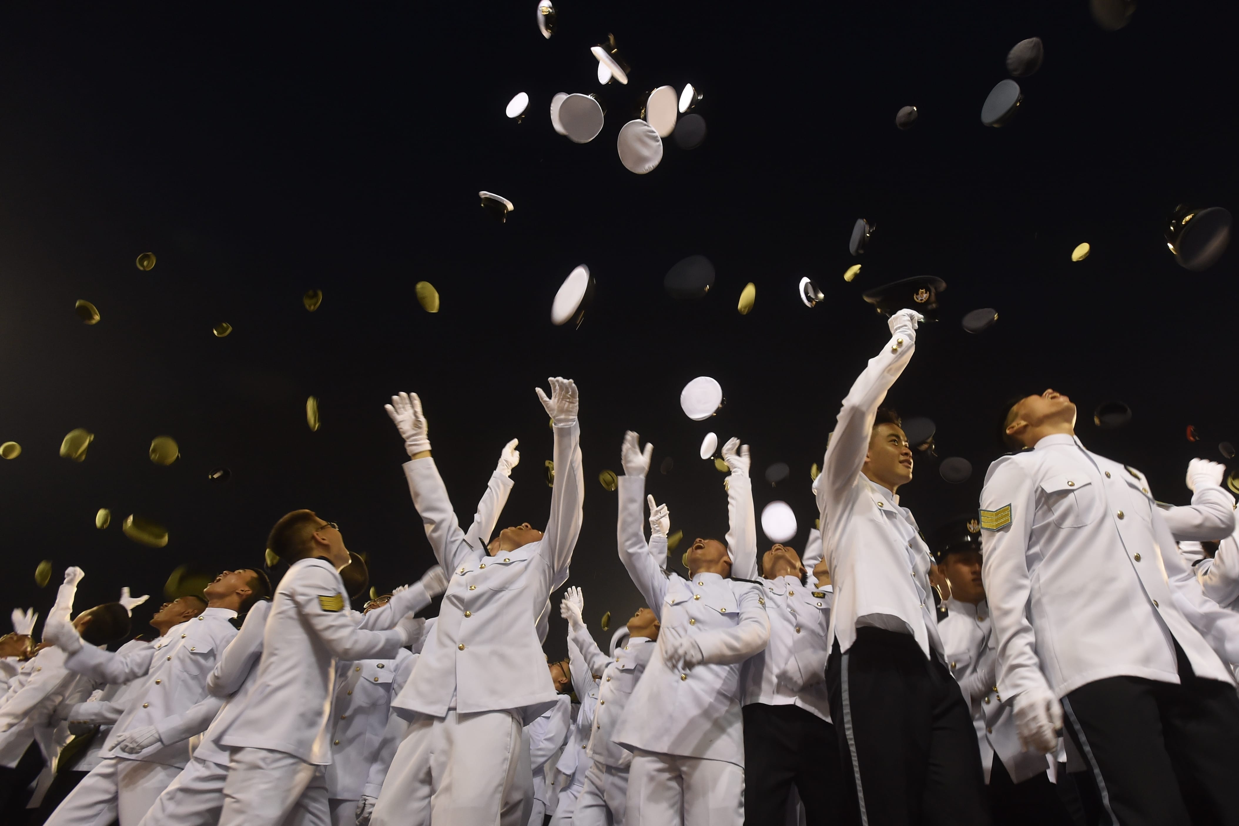 The Specialists of the Singapore Armed Forces tossing their headdresses at the end of their graduation parade.