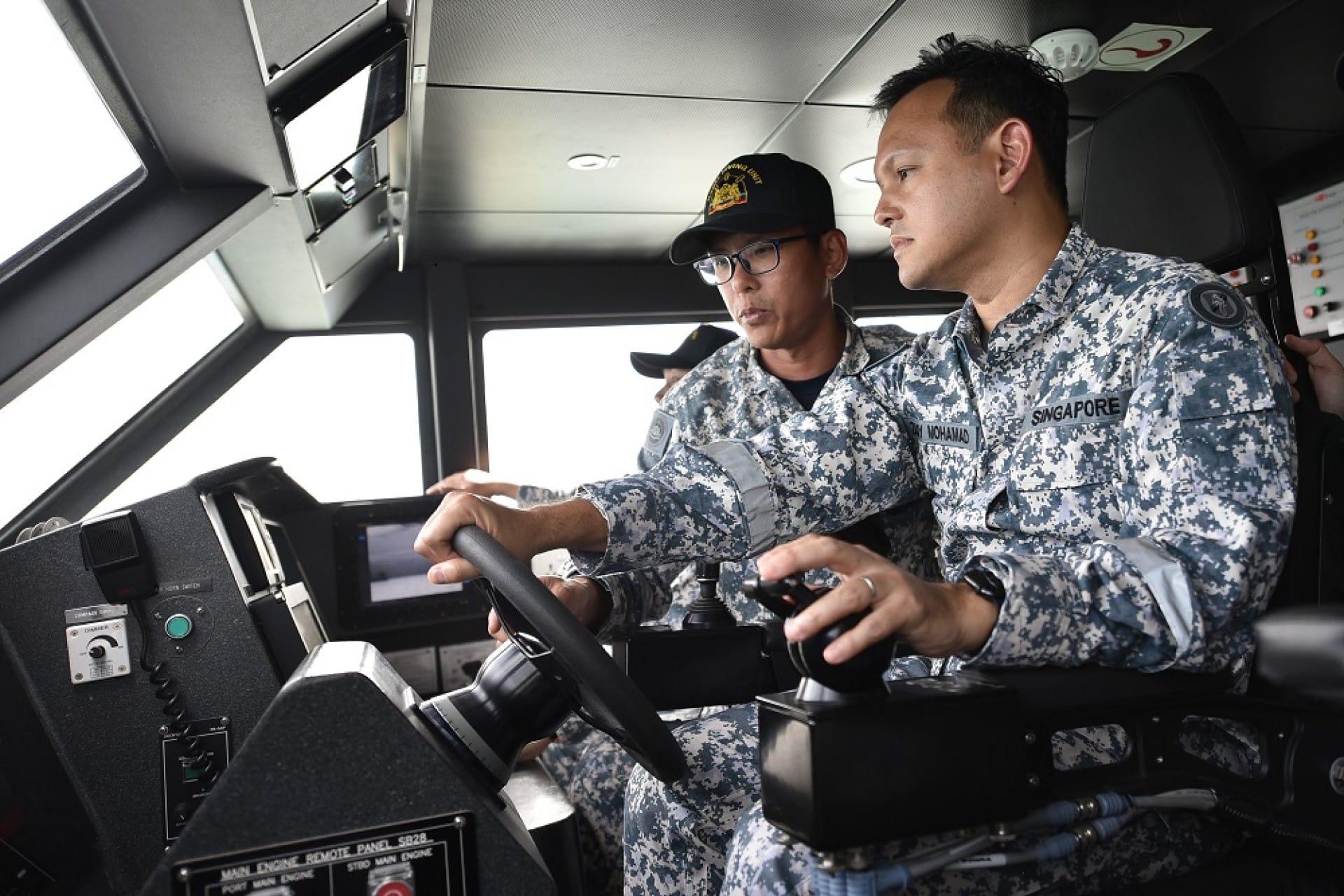 Senior Minister of State for Defence Mr Zaqy Mohamad at the controls of the Combatant Craft Large.