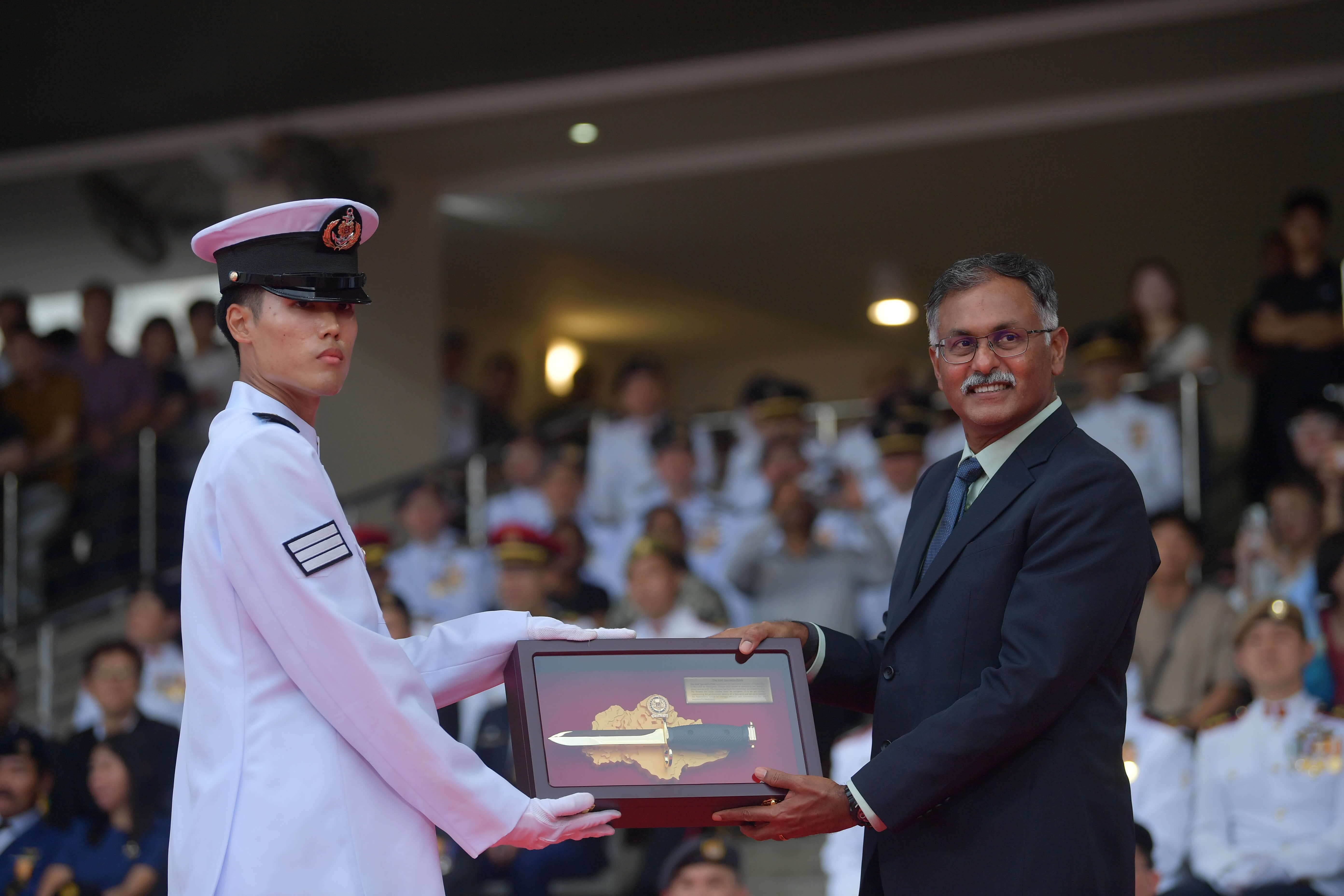 Mr Murali presenting the Golden Bayonet to Third Sergeant (3SG) Xander Lok Kai Yin from the Republic of Singapore Navy during the graduation parade.