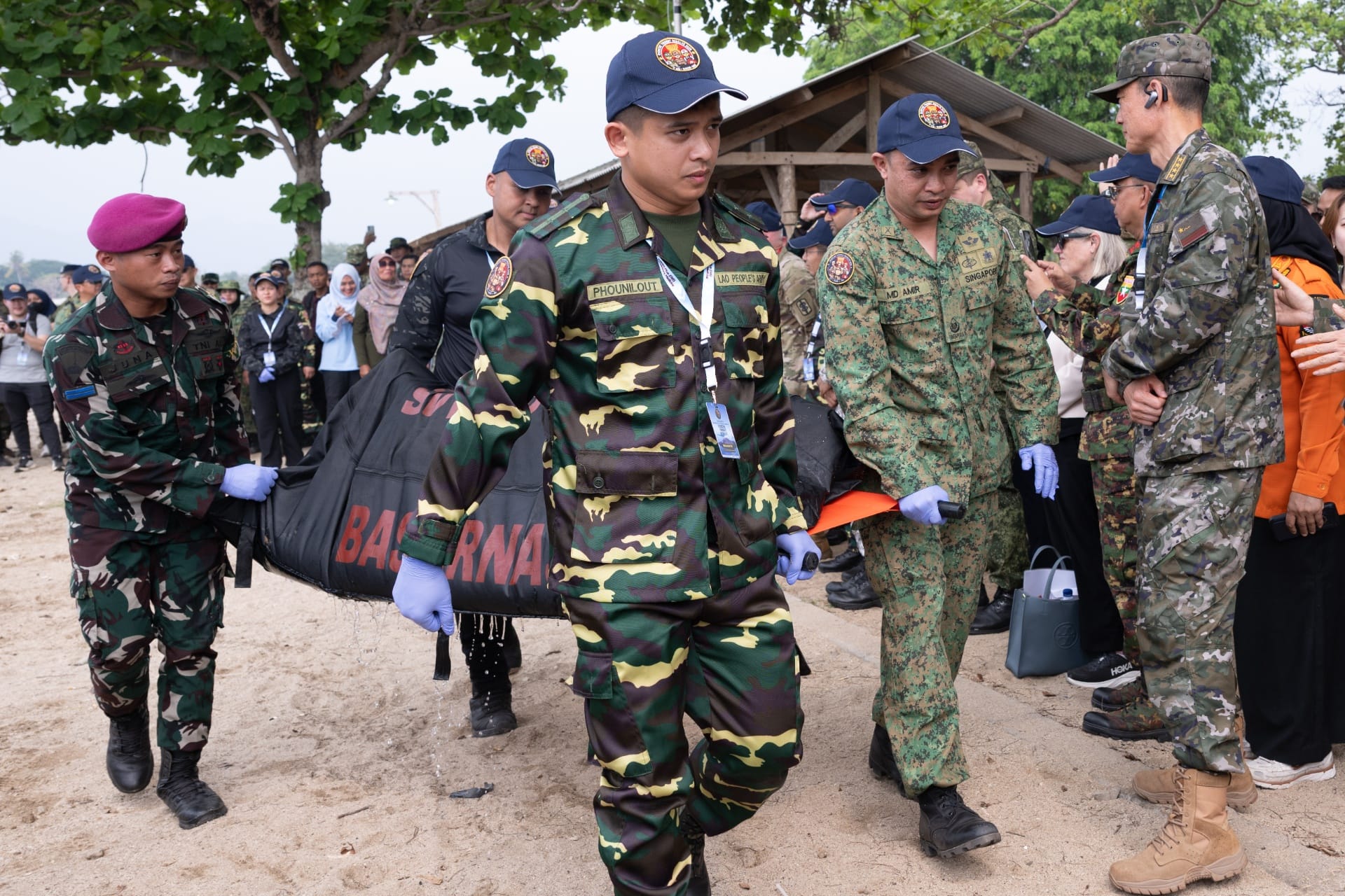 Personnel from participating countries evacuating a simulated casualty during a search and rescue component of Exercise Trident Resolve (XTR) 2026.