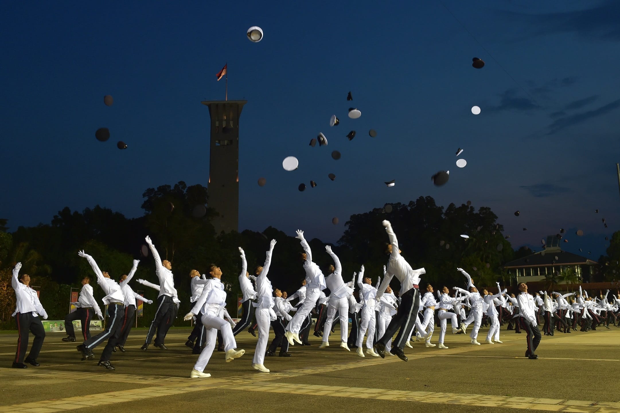 The newly-commissioned officers tossing their peak caps to mark the completion of their 38-week course.